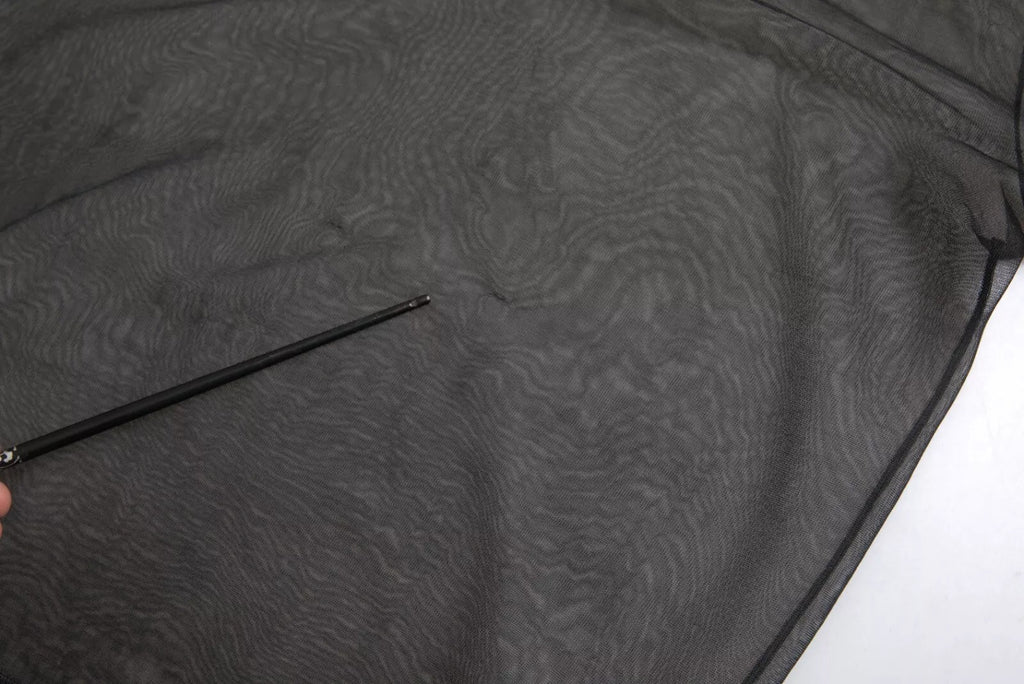 Blouse transparente en maille noire de Dolce & Gabbana avec col roulé et design moulant.