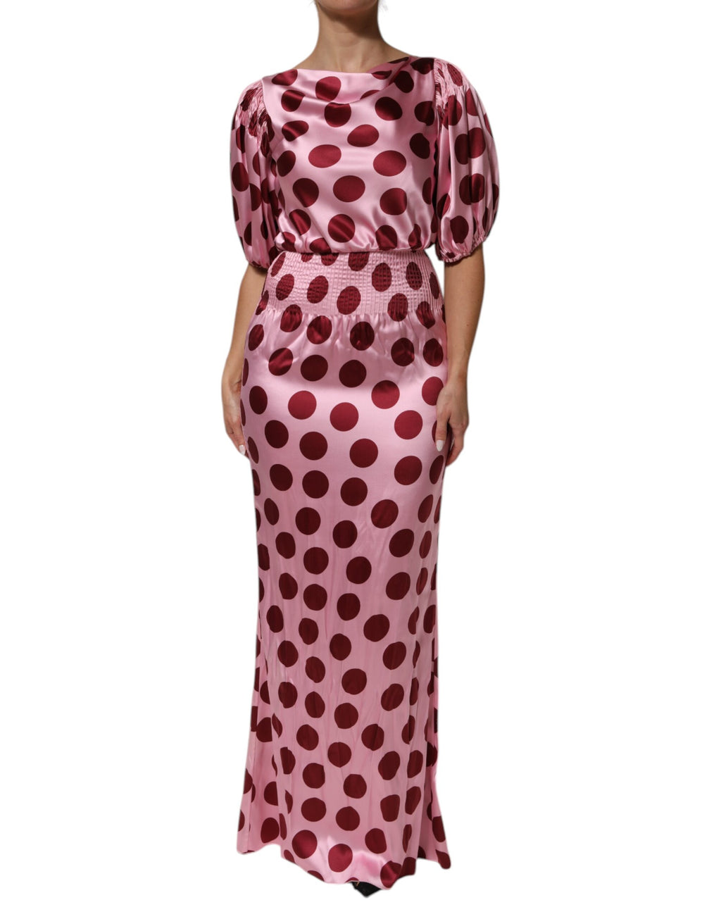 Robe longue en soie satin rose et rouge à pois Dolce & Gabbana, élégante et fluide, portée avec finesse.
