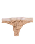 String thong en dentelle beige Dolce & Gabbana avec logo, taille élastique et design élégant visible sur l'image.