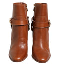 Bottes ankle en cuir marron Dolce & Gabbana avec boucle logo DG, chaussures élégantes et sophistiquées.