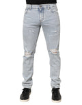 Jeans slim déchirés Dolce & Gabbana Light Blue en denim bleu clair avec détails usés et coupe ajustée.
