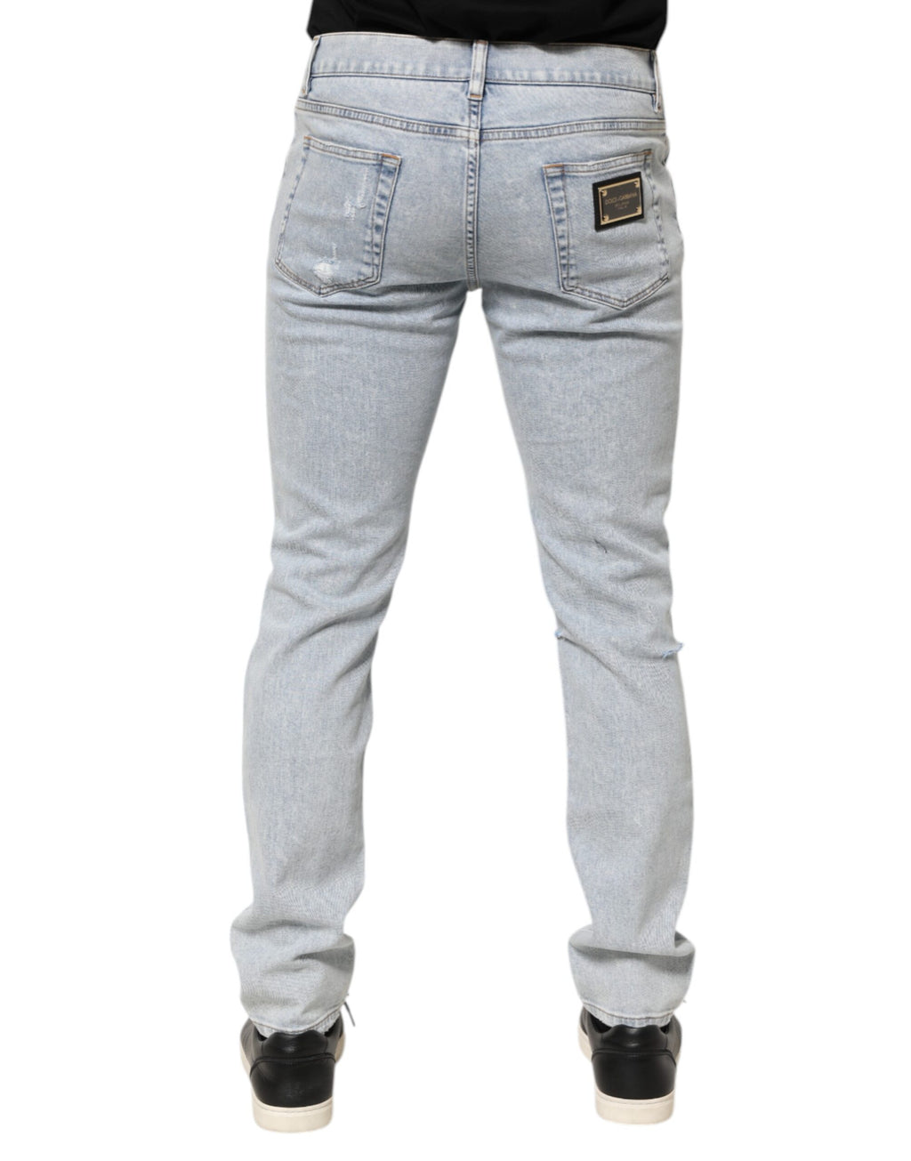 Jeans slim déchirés Dolce & Gabbana Light Blue, denim clair, coupe ajustée, avec détails effilochés et usés.