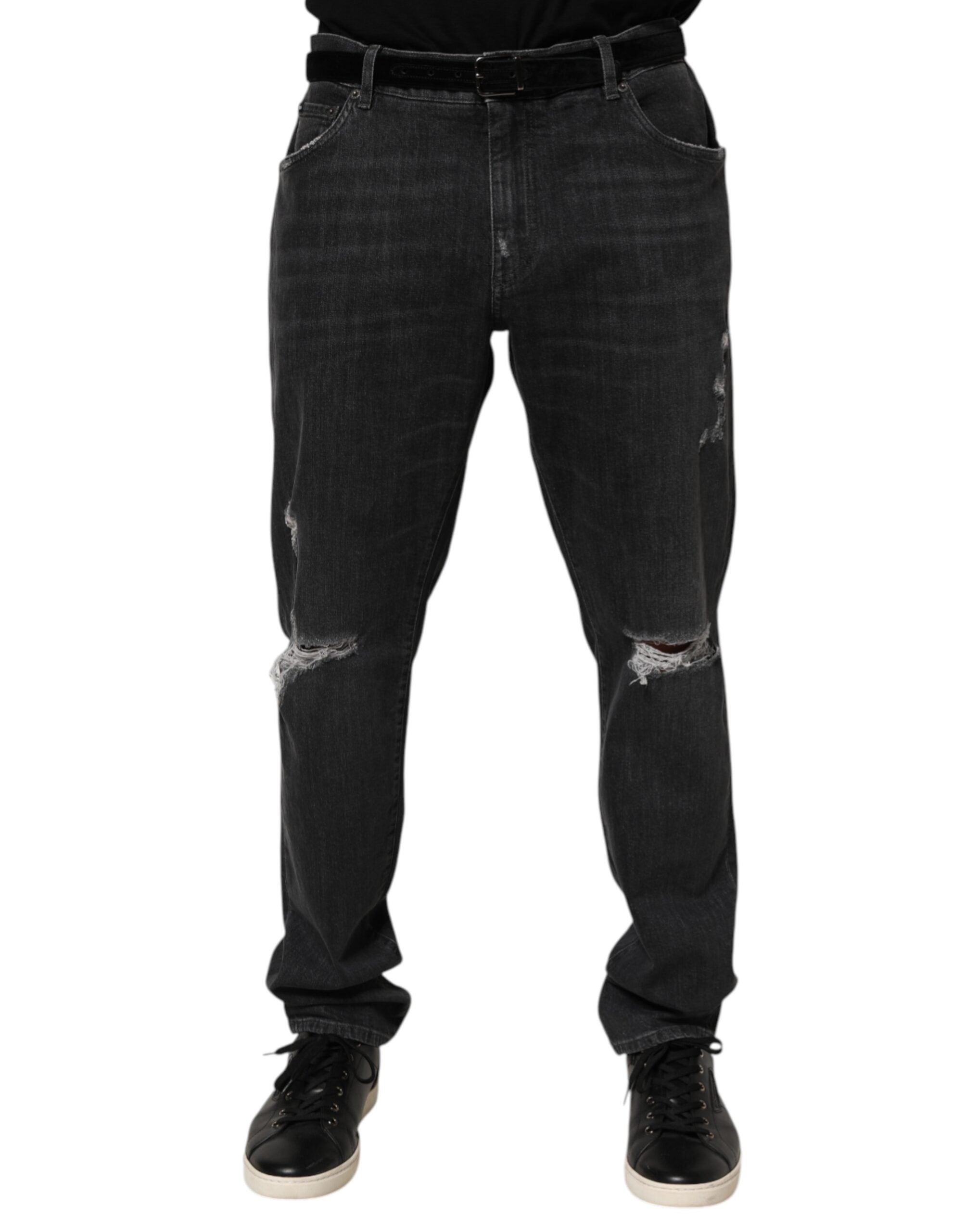 Jeans slim noir en coton Dolce & Gabbana avec déchirures, effet usé et logo visible, mode masculine élégante.