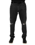 Jeans slim en coton noir de Dolce & Gabbana avec déchirures, logo et style décontracté.