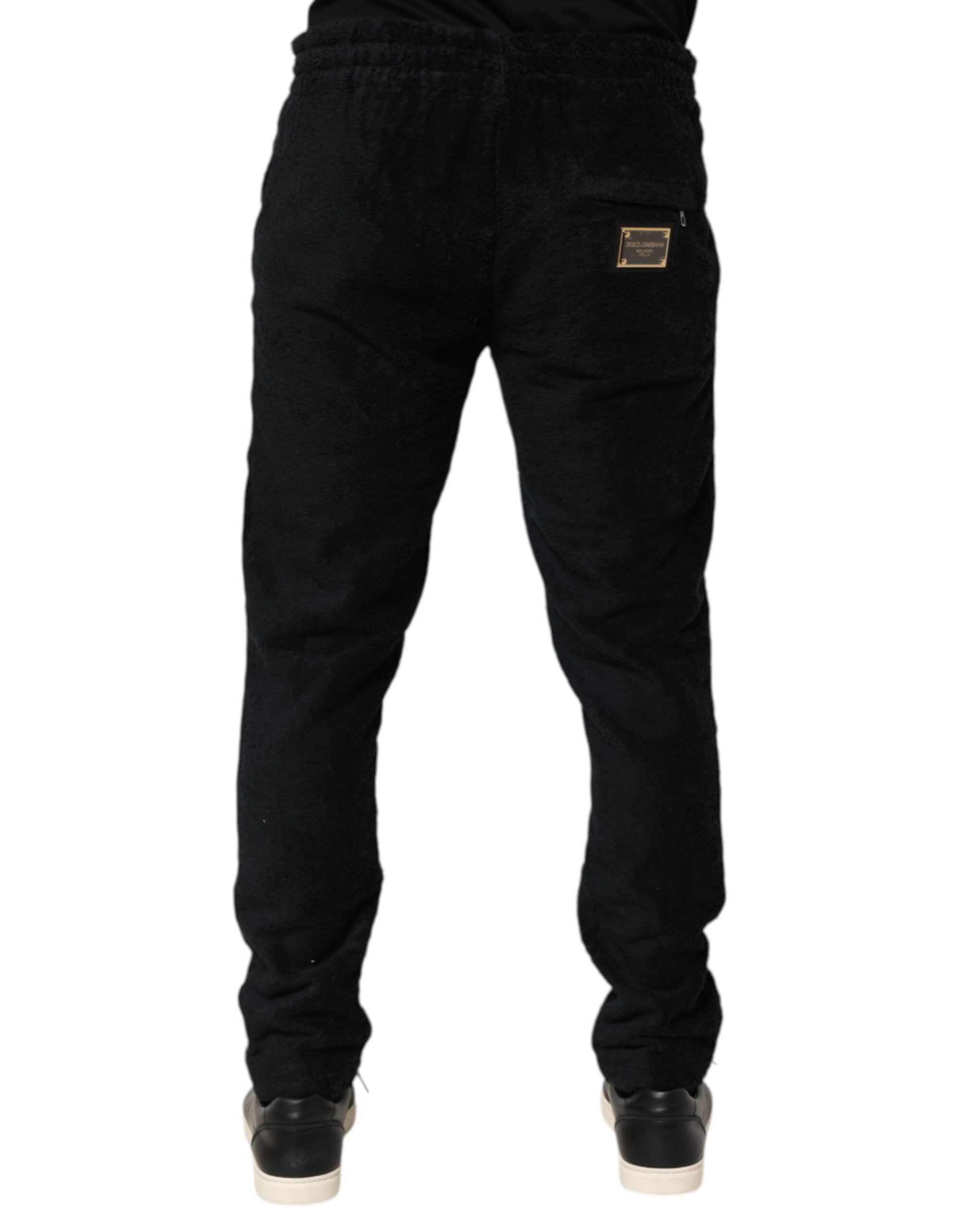 Pantalon jogger homme Dolce & Gabbana en coton noir avec logo, style décontracté et moderne, visible avec détails de la marque.