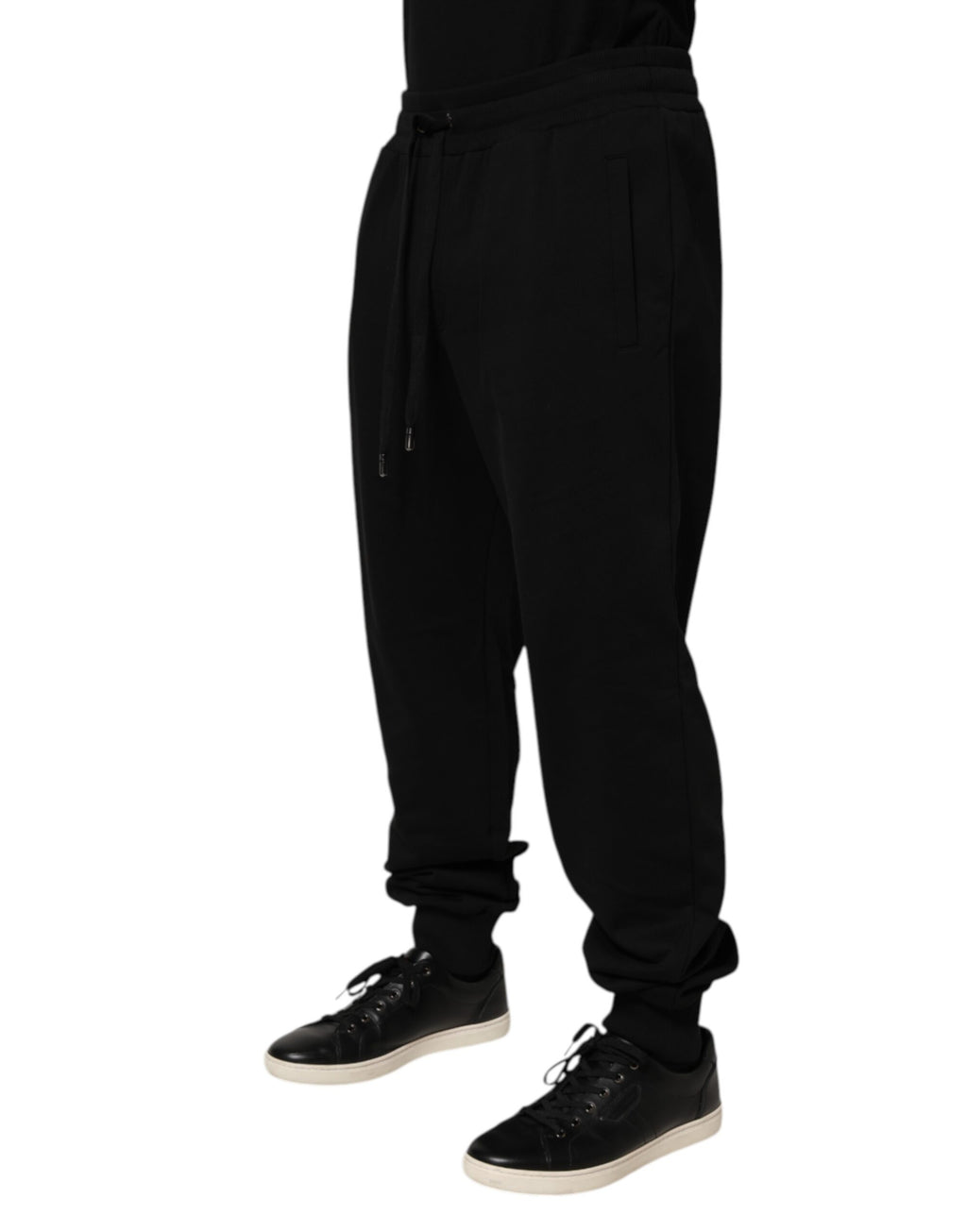Pantalon de survêtement noir en coton Dolce & Gabbana avec cordon de serrage et logo, vue de face.