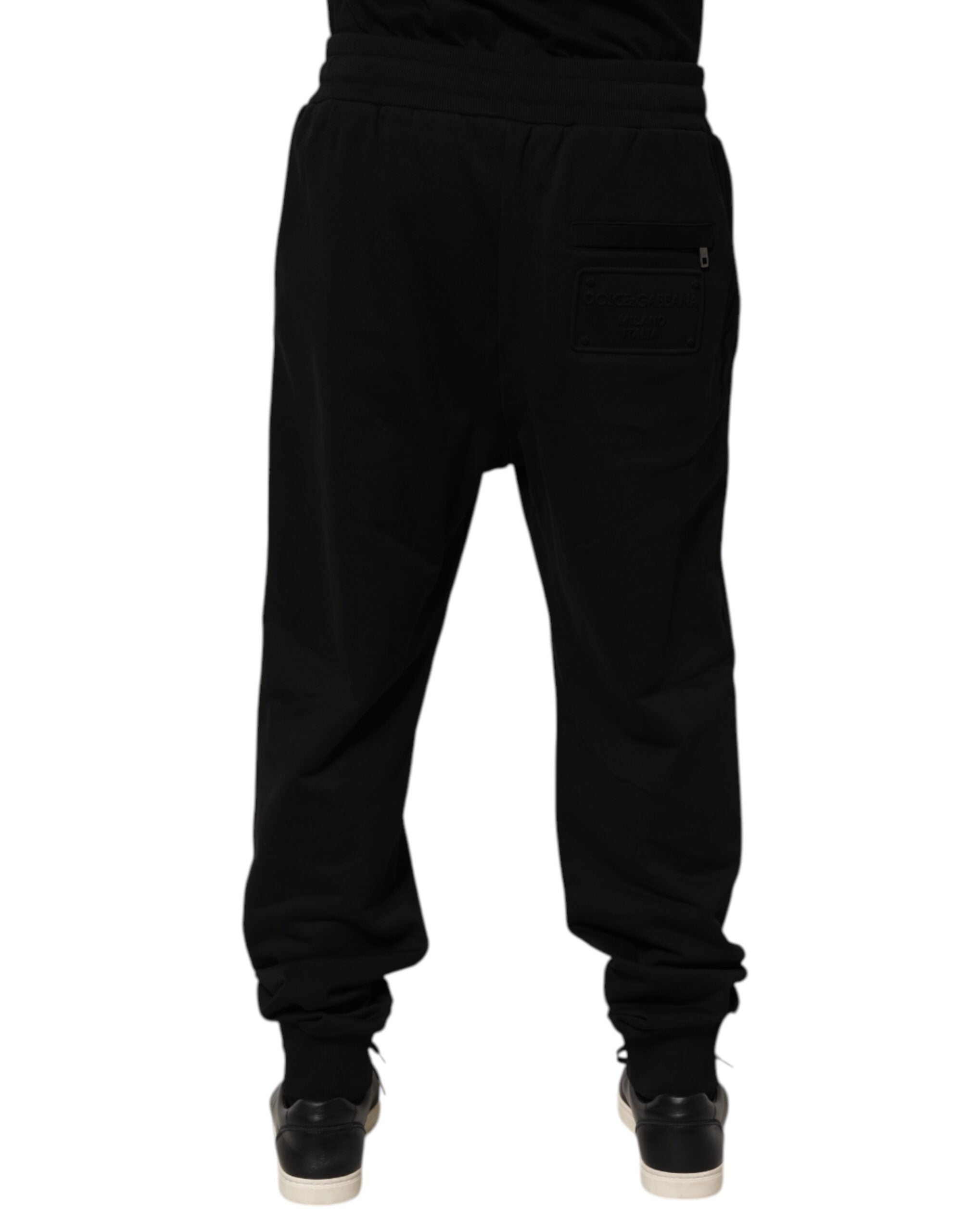 Pantalon de survêtement noir en coton Dolce & Gabbana avec cordon de serrage et logo visible.