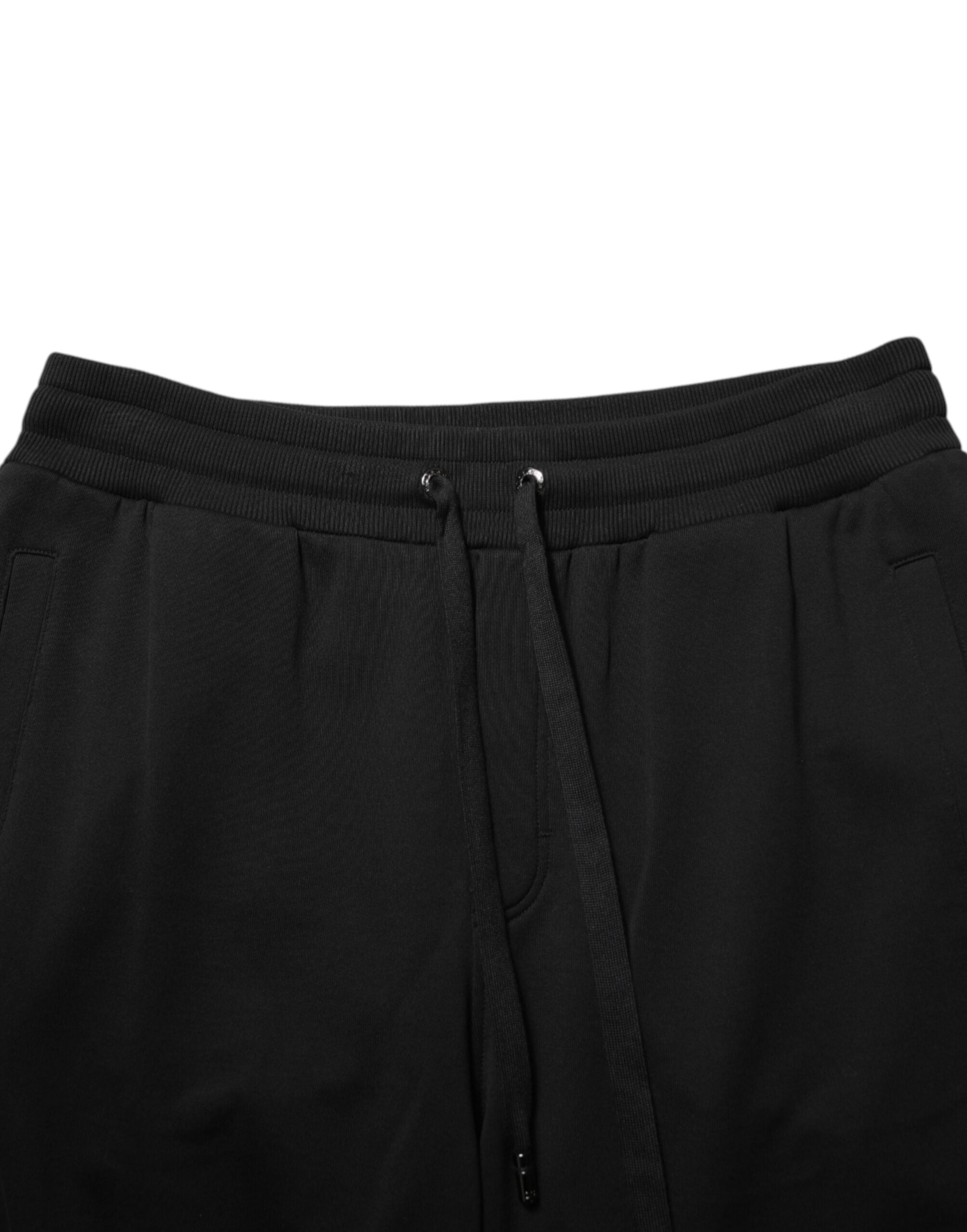 Pantalon de jogging noir Dolce & Gabbana en coton avec cordon de serrage et logo visible, style décontracté et élégant.