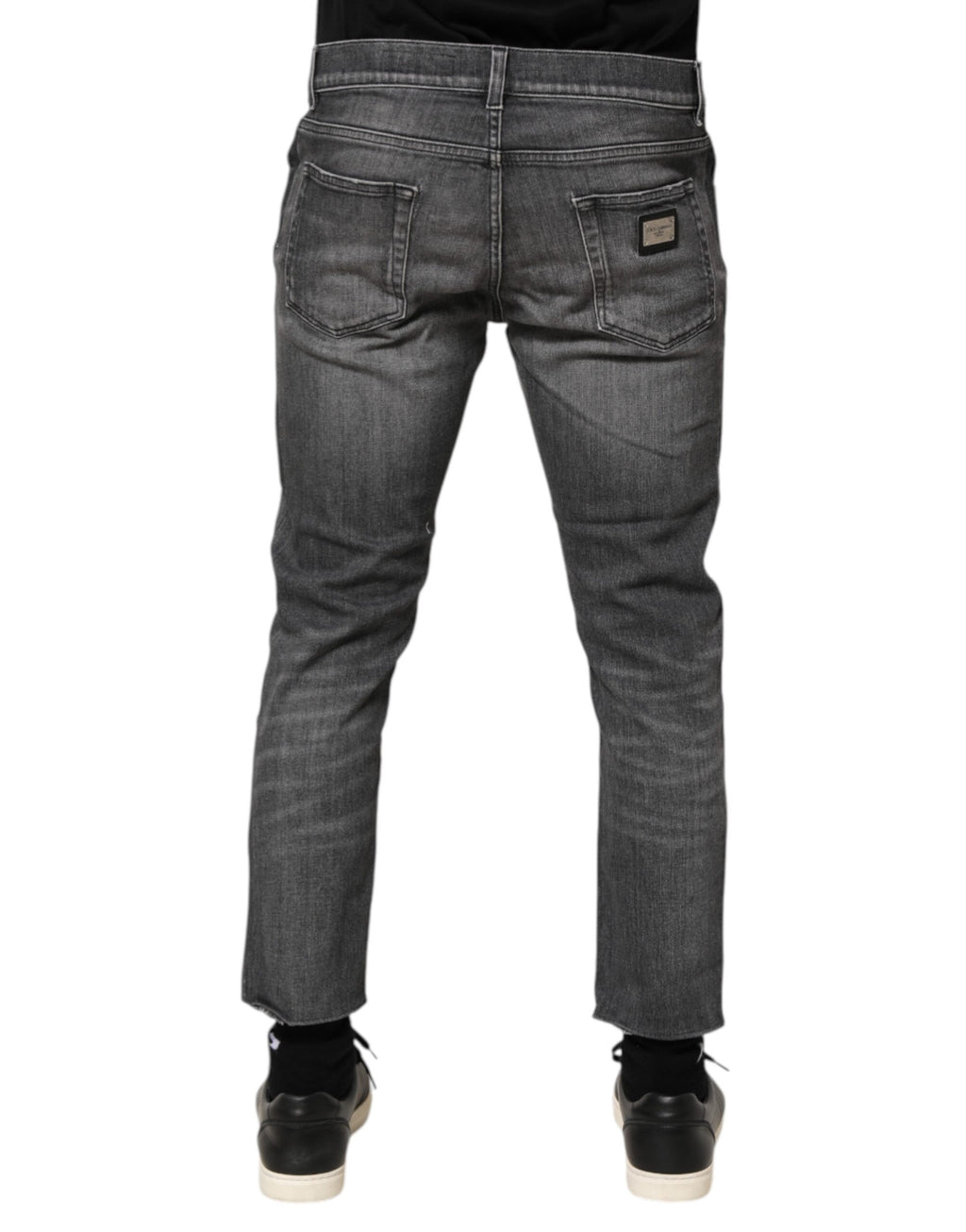 Jeans slim en denim gris en coton de Dolce & Gabbana avec détails déchirés et style ajusté, visibles sur l'image.