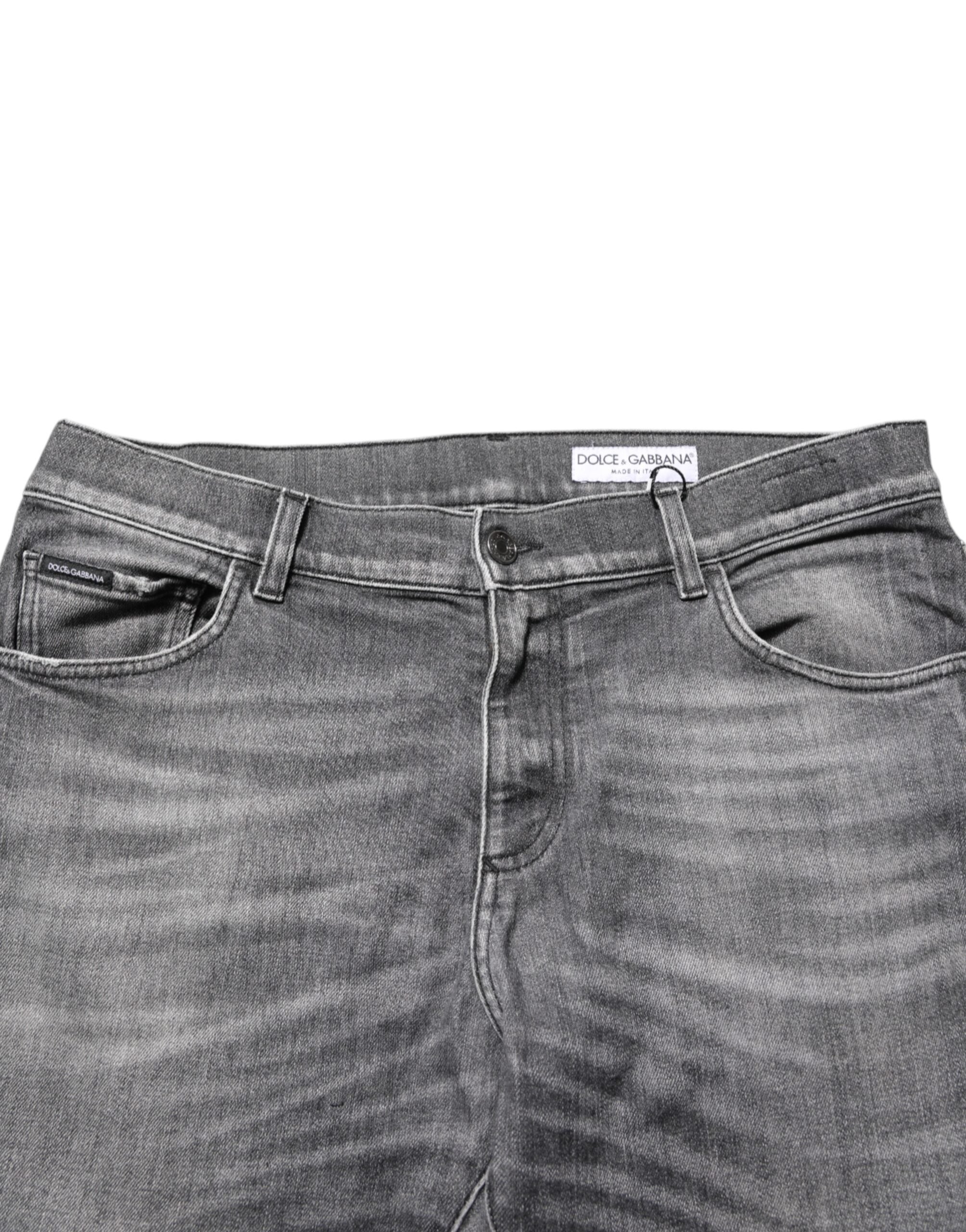 Pantalons slim en denim gris en coton Dolce & Gabbana avec déchirures et style décontracté, visibles sur l'image.