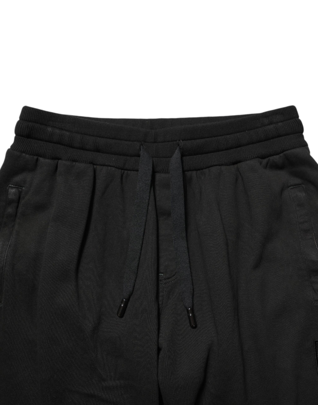 Pantalon jogger homme en coton noir Dolce & Gabbana avec logo DG visible, décontracté et confortable.