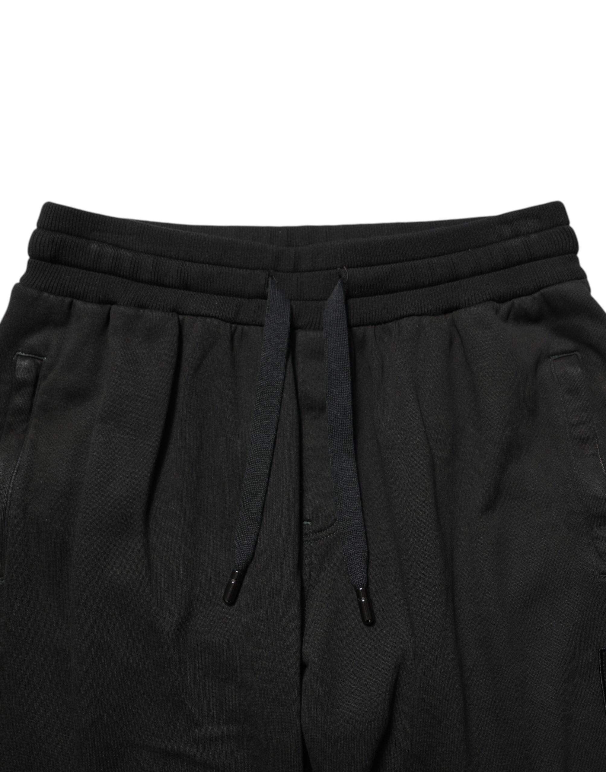 Pantalon jogger homme en coton noir Dolce & Gabbana avec logo DG visible, décontracté et confortable.
