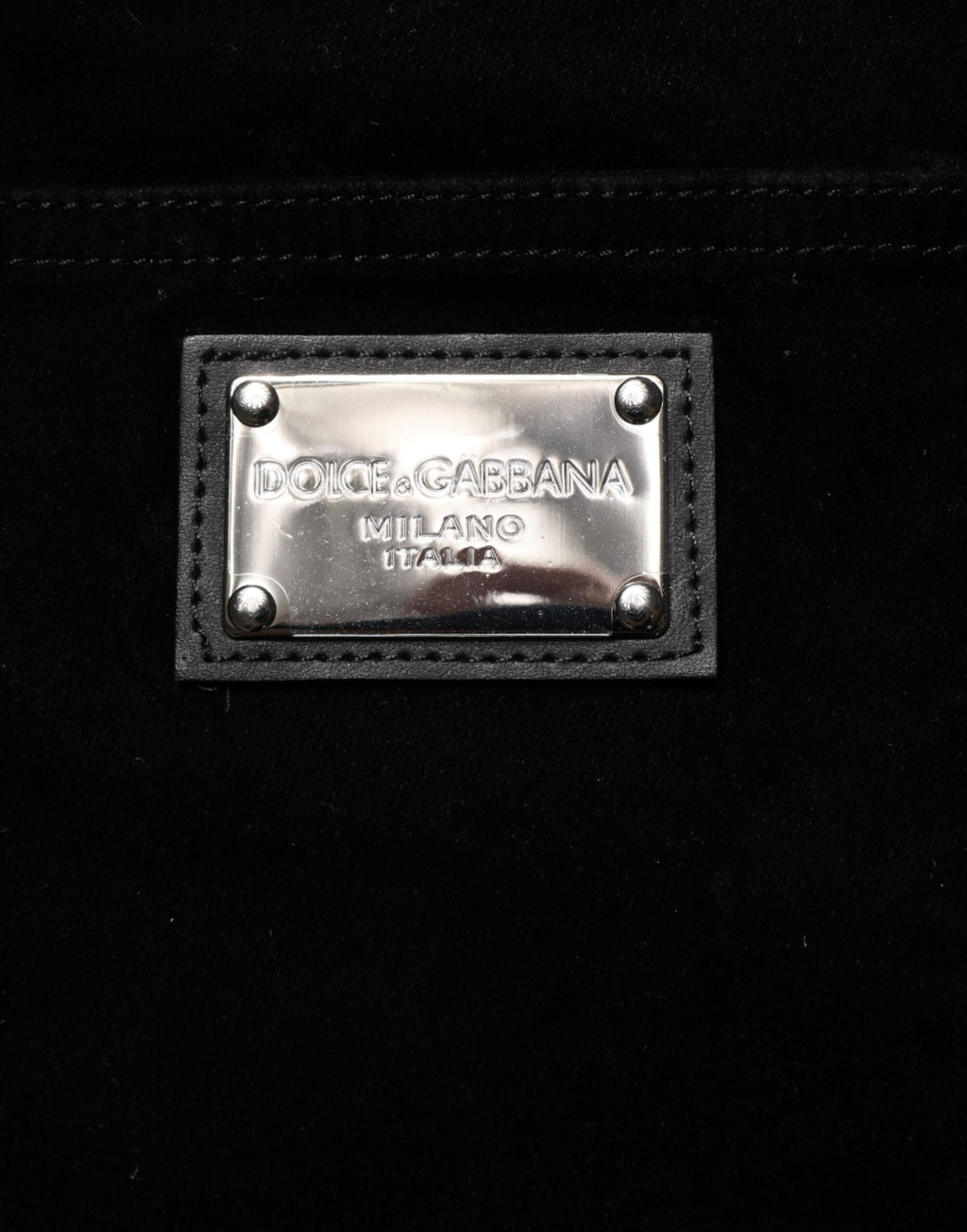 Pantalon slim en denim noir Dolce & Gabbana en coton, ajusté et tendance, visible en gros plan.