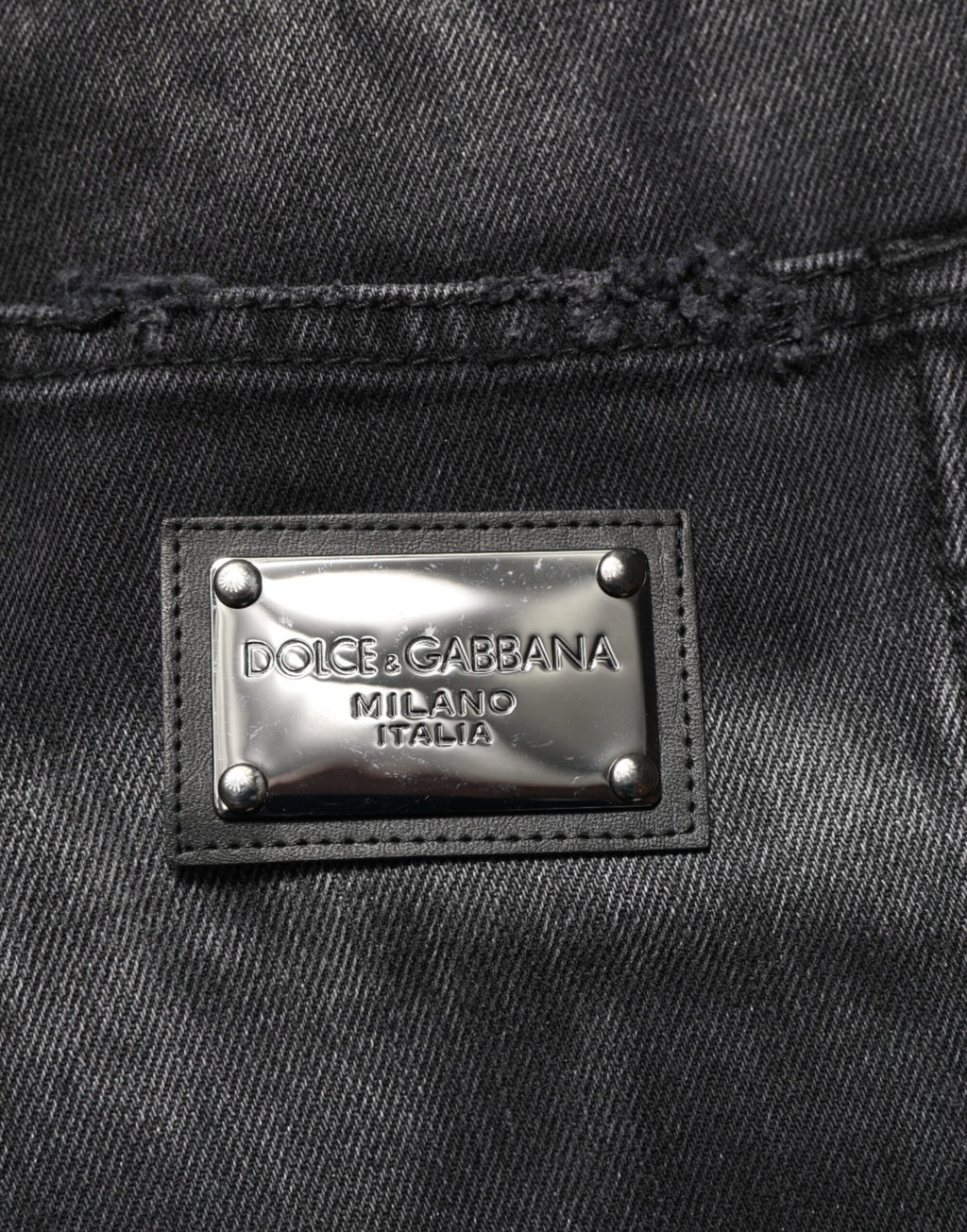 Jeans homme Dolce & Gabbana en denim noir à effet marbré, coupe droite, style élégant et moderne.