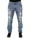 Jeans en denim coton slim tressé bleu Dolce & Gabbana avec déchirures et coupe ajustée, visibles sur l'image.
