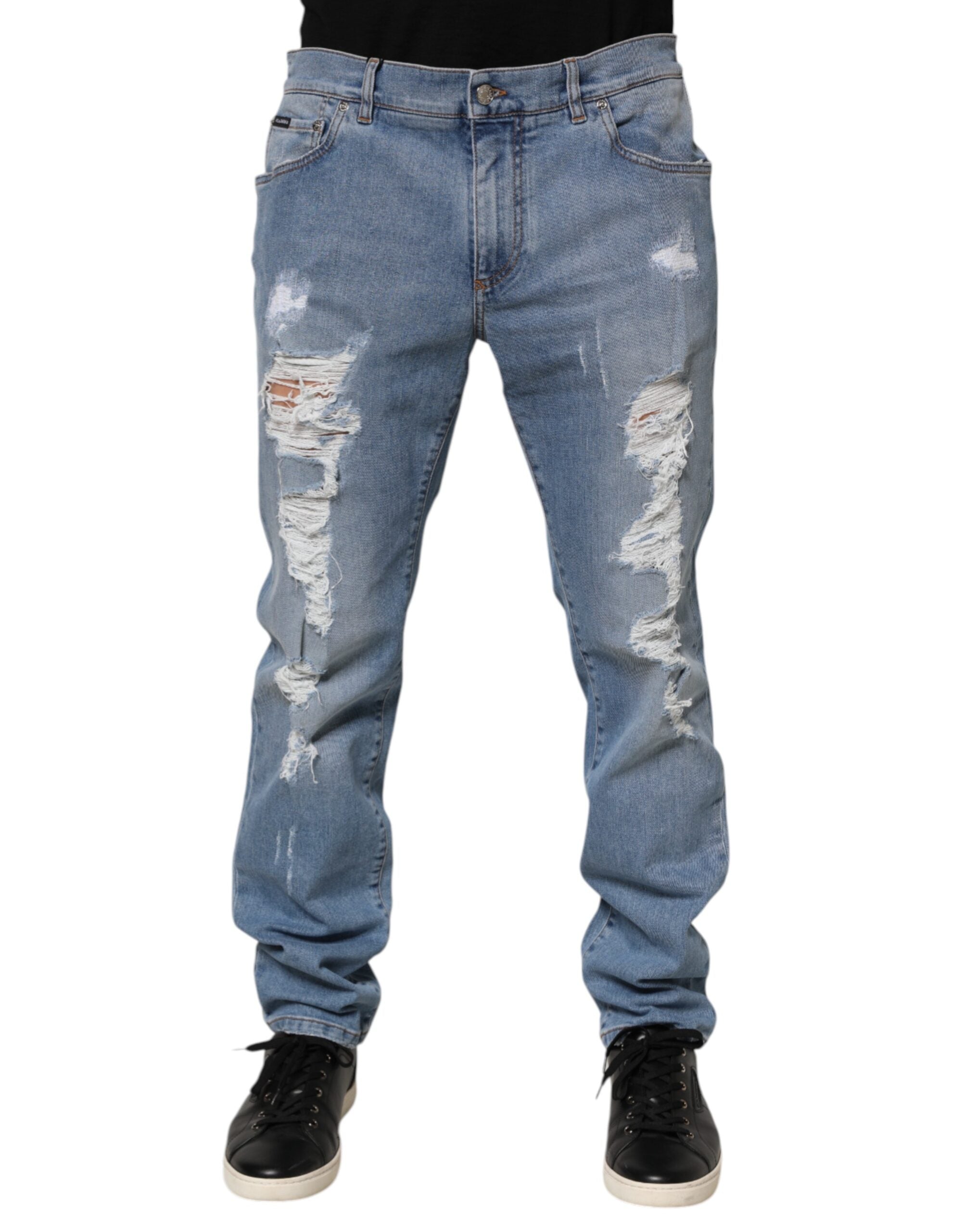 Jeans slim déchirés en denim en coton bleu de Dolce & Gabbana, coupe ajustée et détails usés.