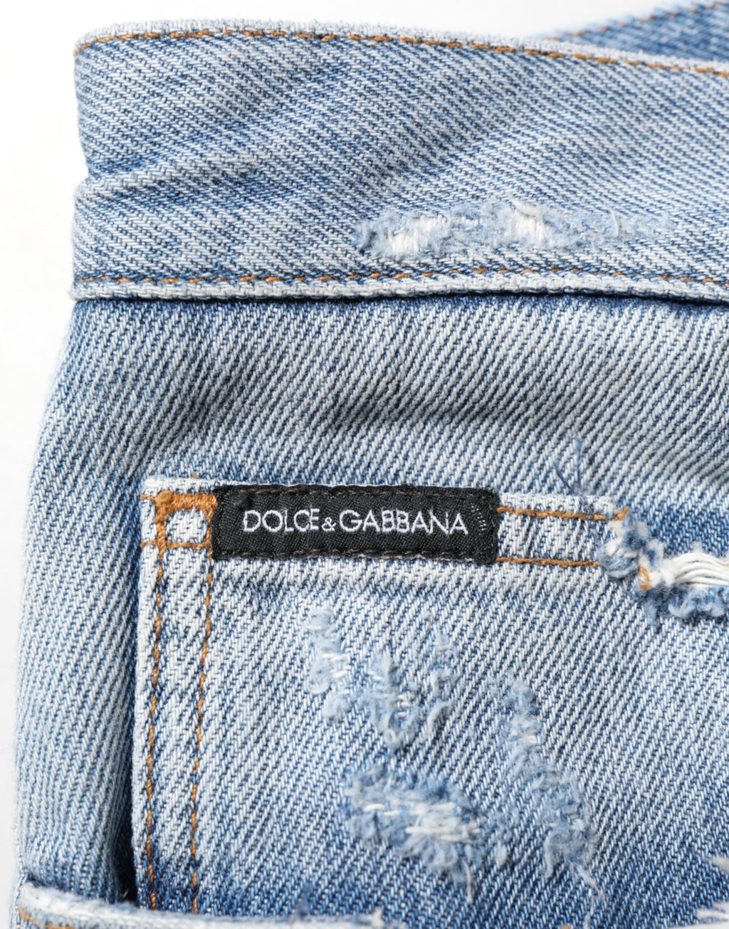 Jean en denim déchiré bleu Dolce & Gabbana, pantalon décontracté avec détails usés et style tendance.