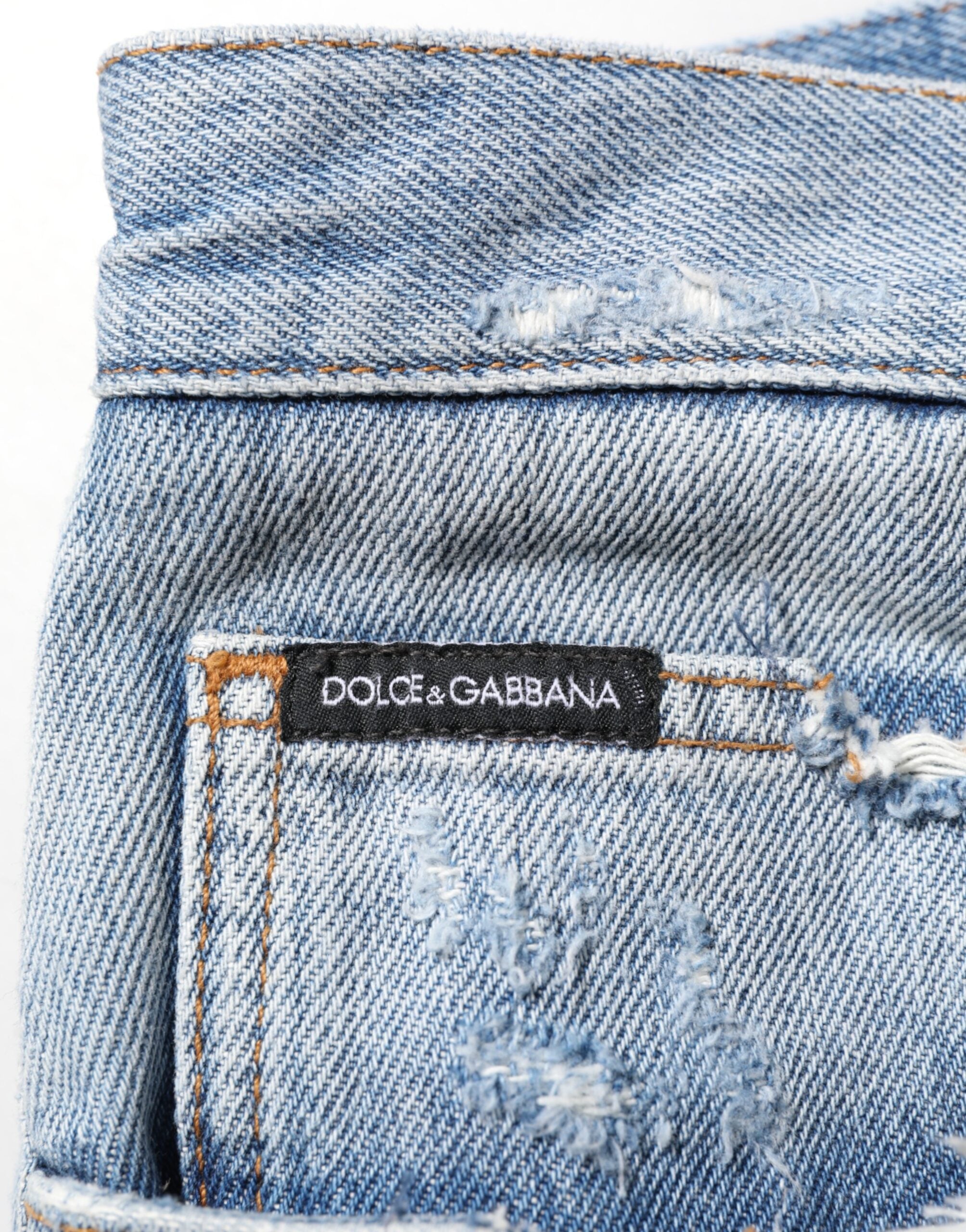 Jean en denim déchiré bleu Dolce & Gabbana, pantalon décontracté avec détails usés et style tendance.