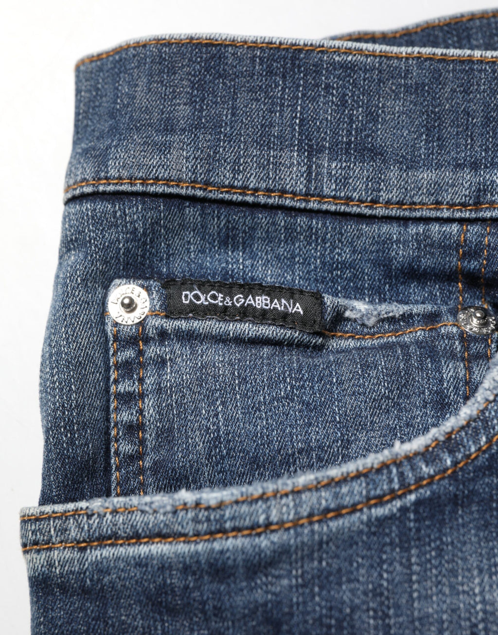 Jeans homme Dolce & Gabbana bleu foncé délavé avec déchirures et style décontracté, en denim robuste.