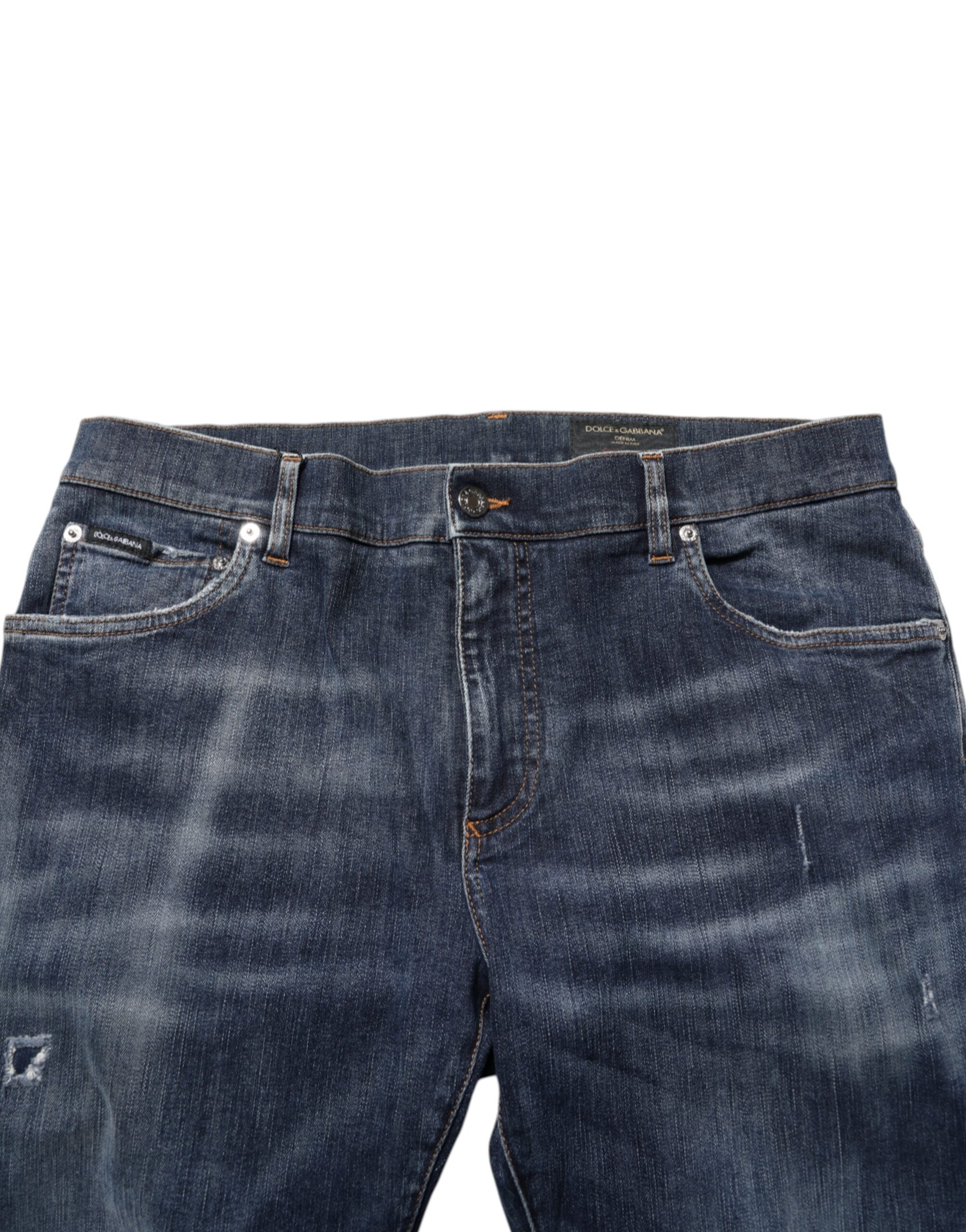 Jeans en denim délavé bleu foncé Dolce & Gabbana, coupe déchirée, style décontracté, visible sur l'image.