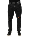 Jeans en denim noir délavé et déchiré de Dolce & Gabbana, coupe ample en coton avec détails usés.