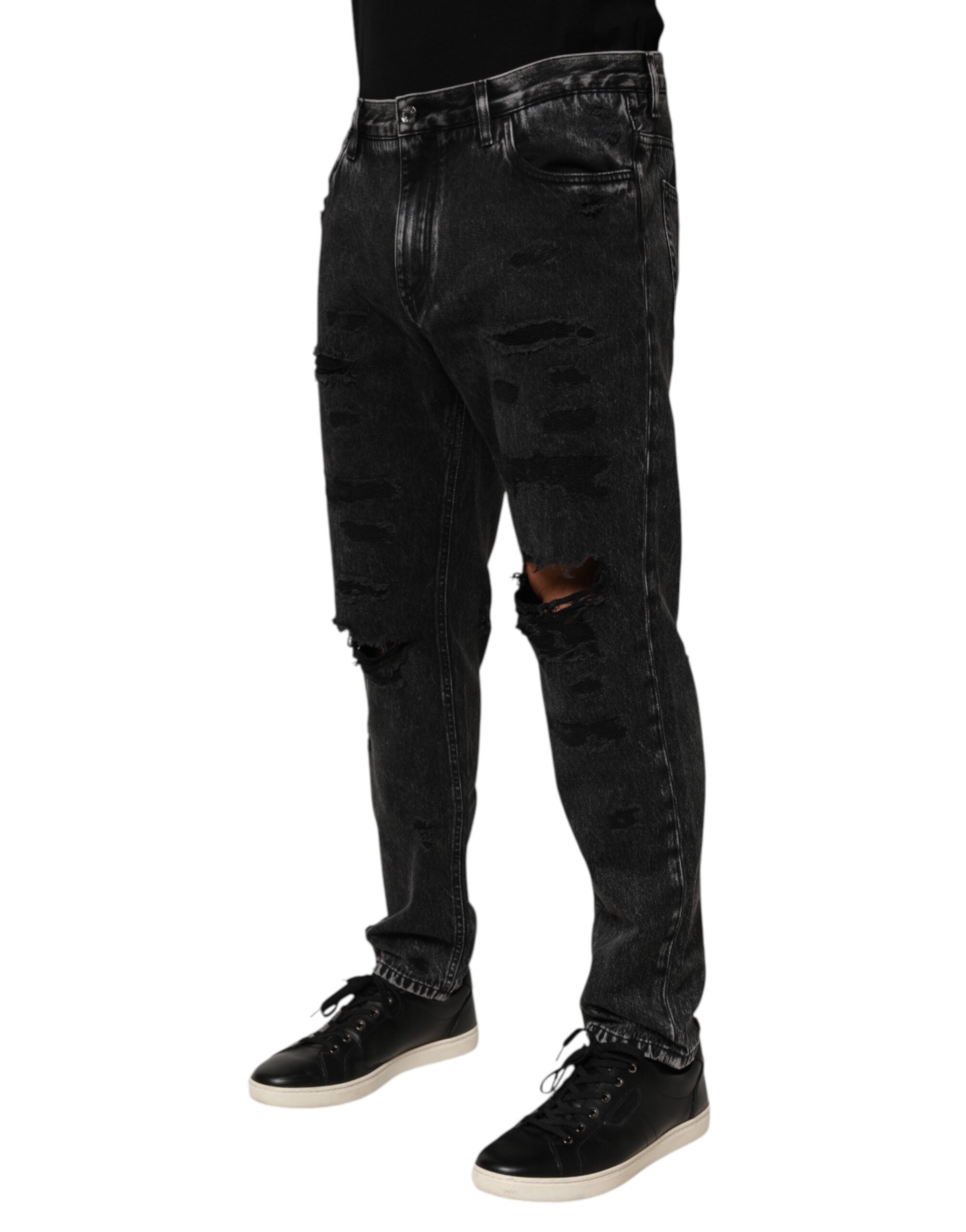 Jeans en denim délavé noir Dolce & Gabbana, déchirés, coupe ample, en coton avec finition usée.