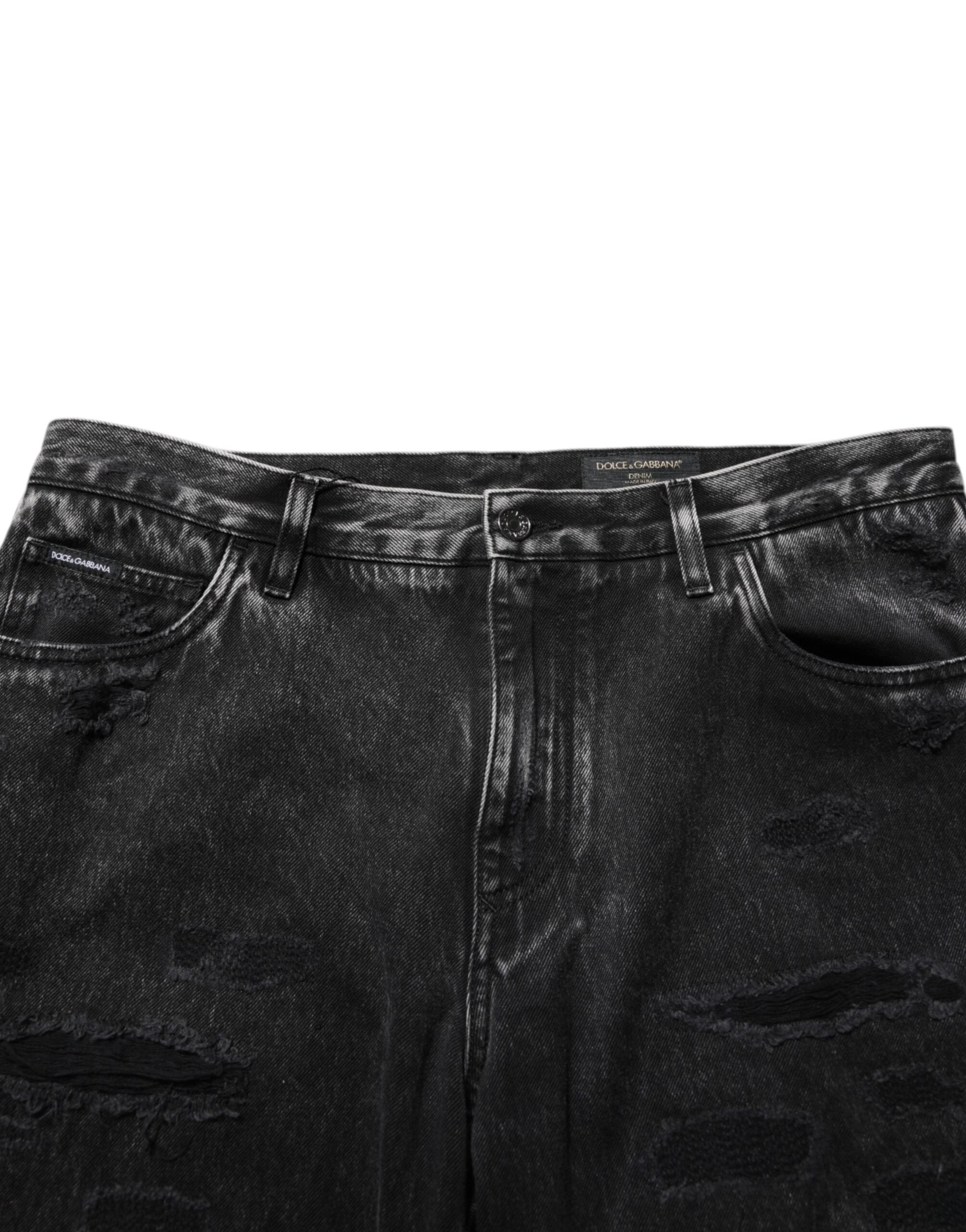 Jeans en coton délavé noir de Dolce & Gabbana, déchirés et amples, avec un style décontracté et tendance.