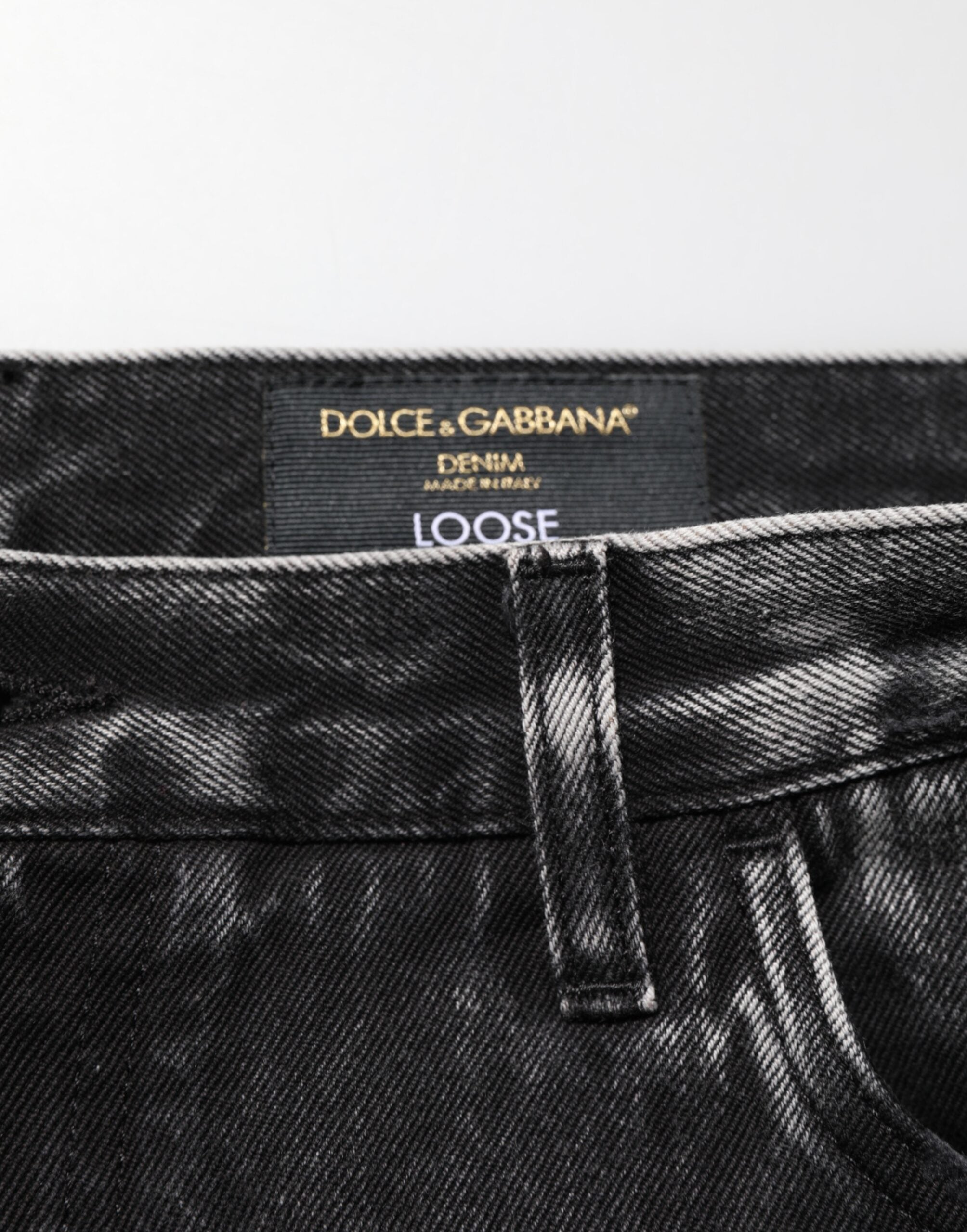 Jeans en jean en coton délavé noir Dolce & Gabbana avec déchirures, coupe ample et style décontracté.