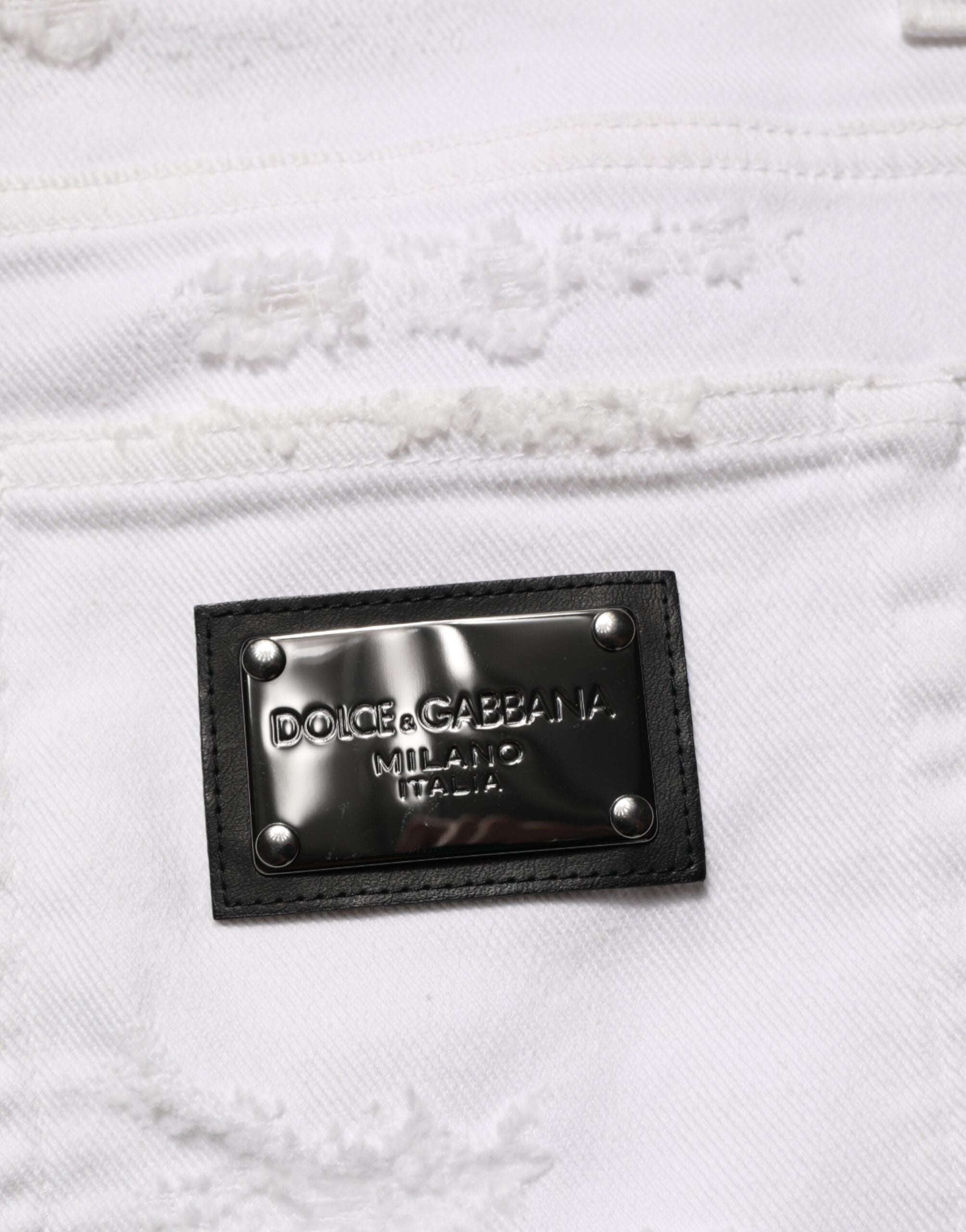 Jeans Dolce & Gabbana en denim blanc déchiré et usé, pantalon décontracté avec style moderne et détails distressed.
