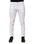 Jeans slim en coton blanc Dolce & Gabbana pour homme, avec déchirures et détails usés, style décontracté et tendance.