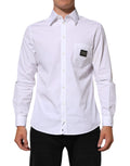 Chemise formelle Dolce & Gabbana blanche avec plaque logo, col élégant et style sophistiqué, vue de face.