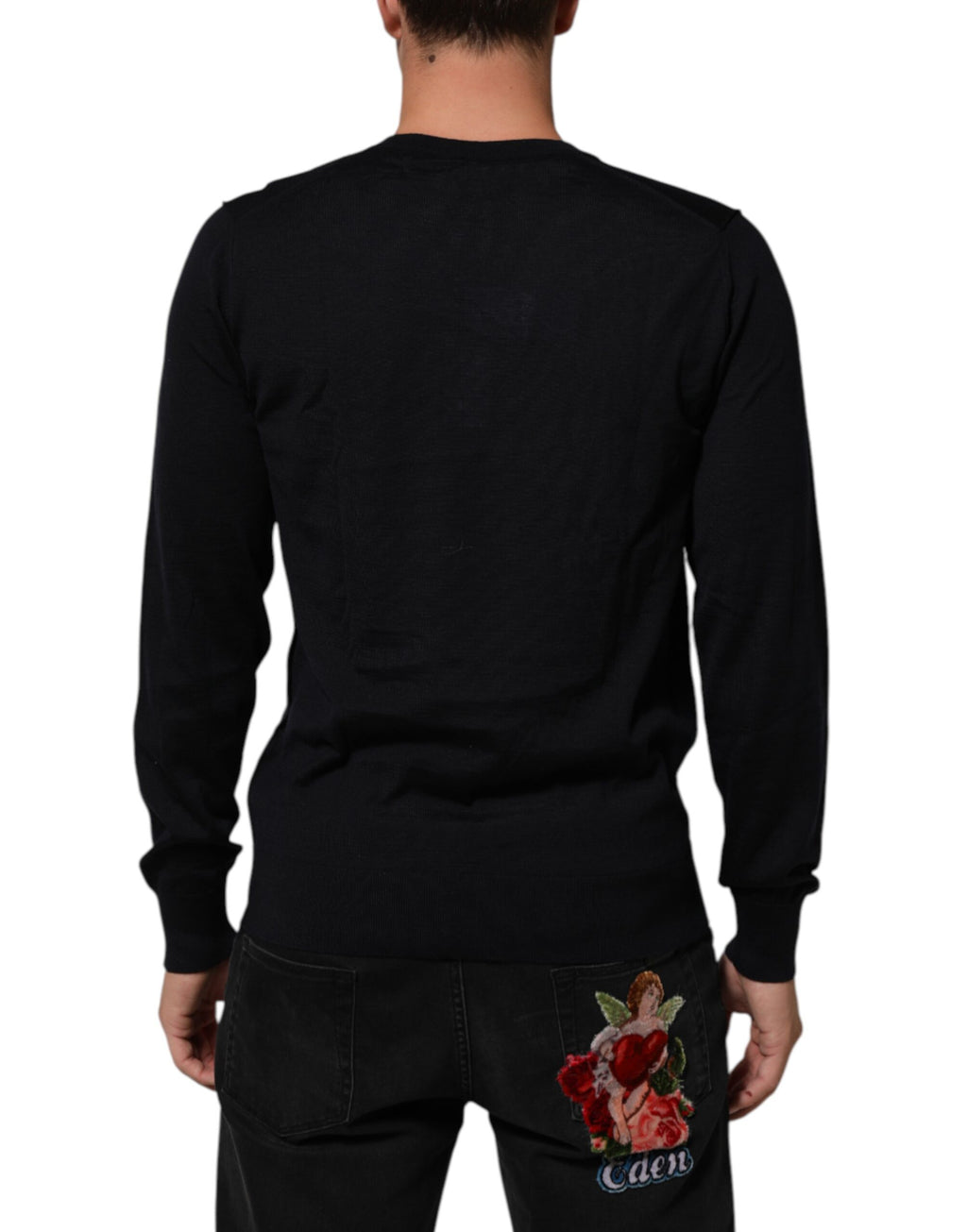 Pull en cachemire noir Dolce & Gabbana à col en V, doux et chaud, porté sur un mannequin.