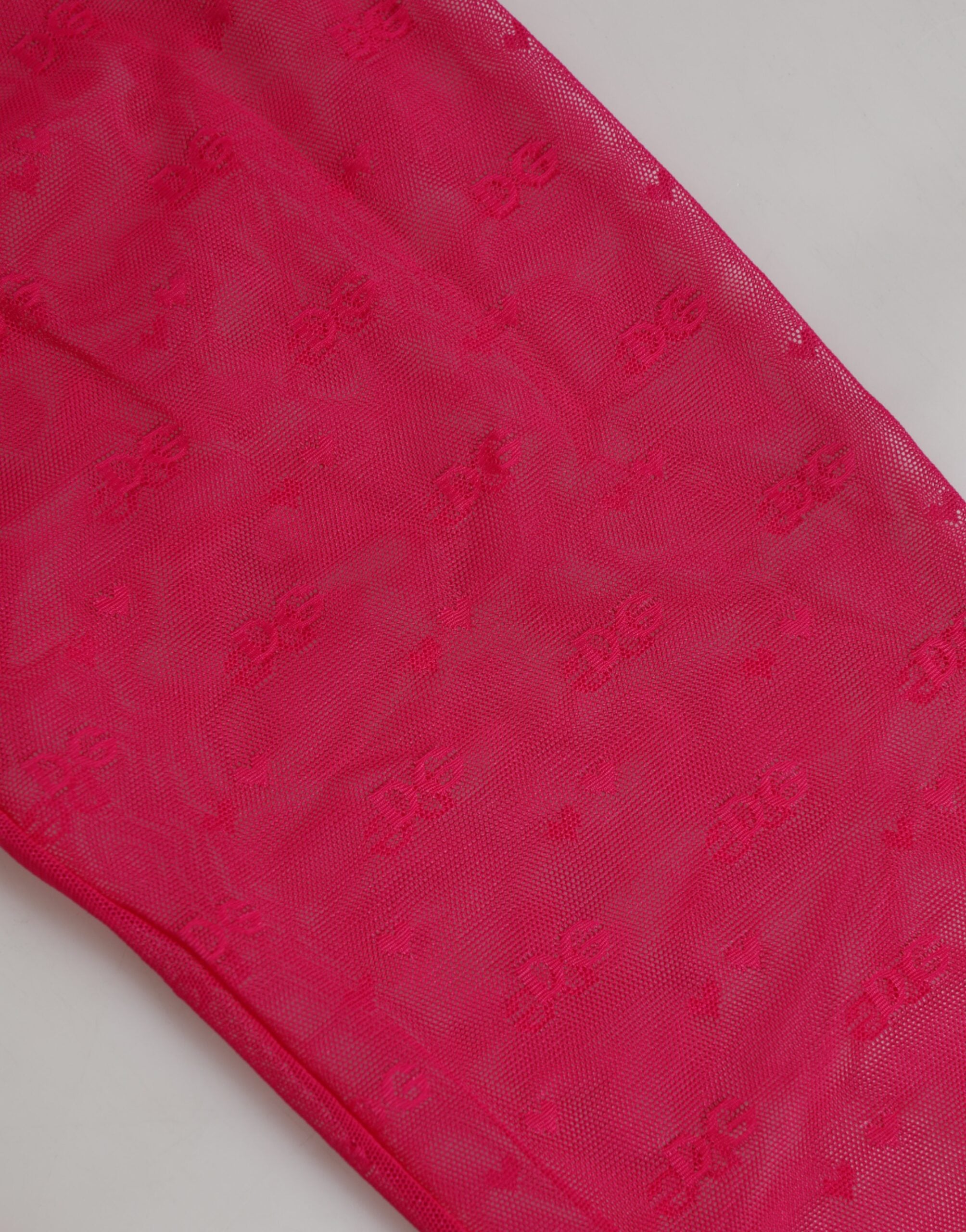 Leggings en nylon fuchsia Dolce & Gabbana avec logo en dentelle, design ajusté et confortable.