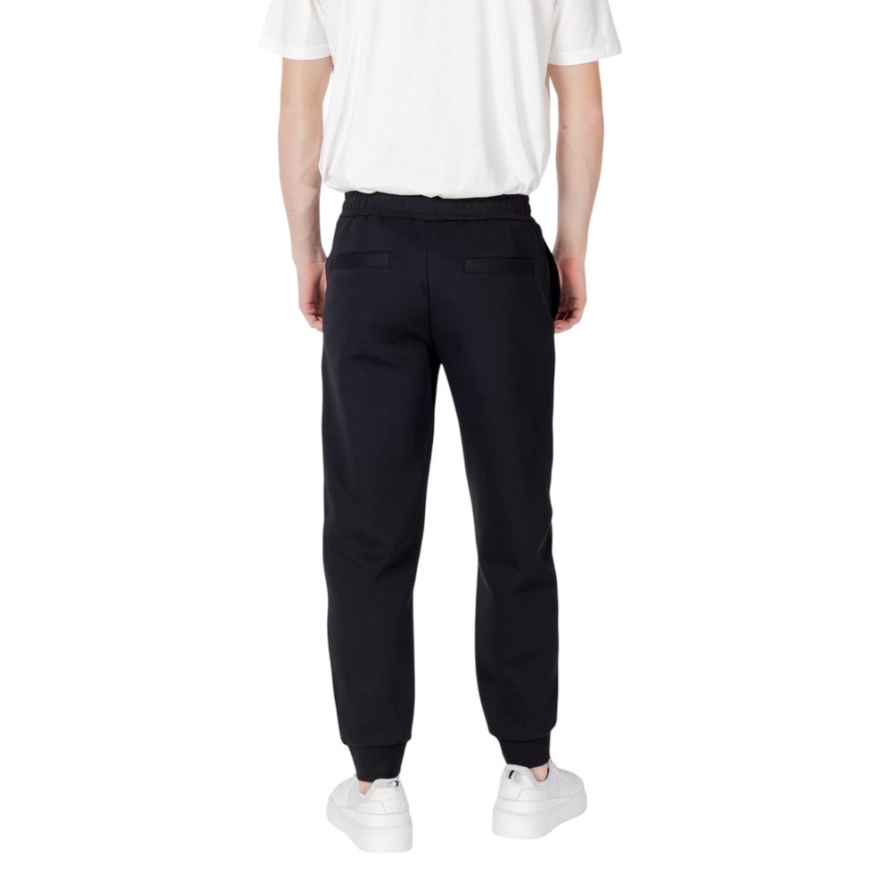 Pantalons de jogging en coton noir Armani Exchange pour homme, vue de face avec détails de la taille et des poches.