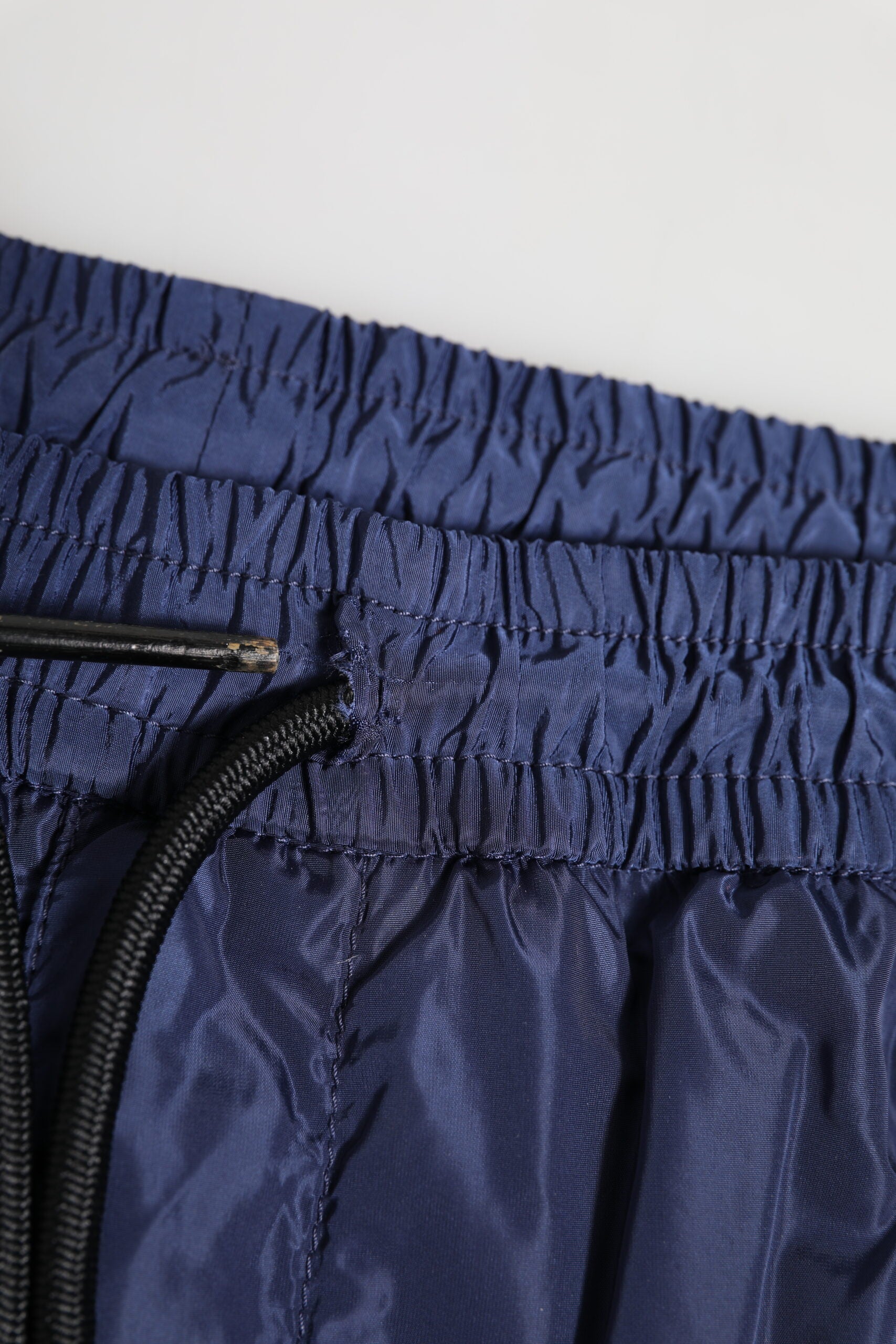 Pantalon jogging droit en nylon bleu Dolce & Gabbana, vue de face, avec ceinture élastique et poches latérales.