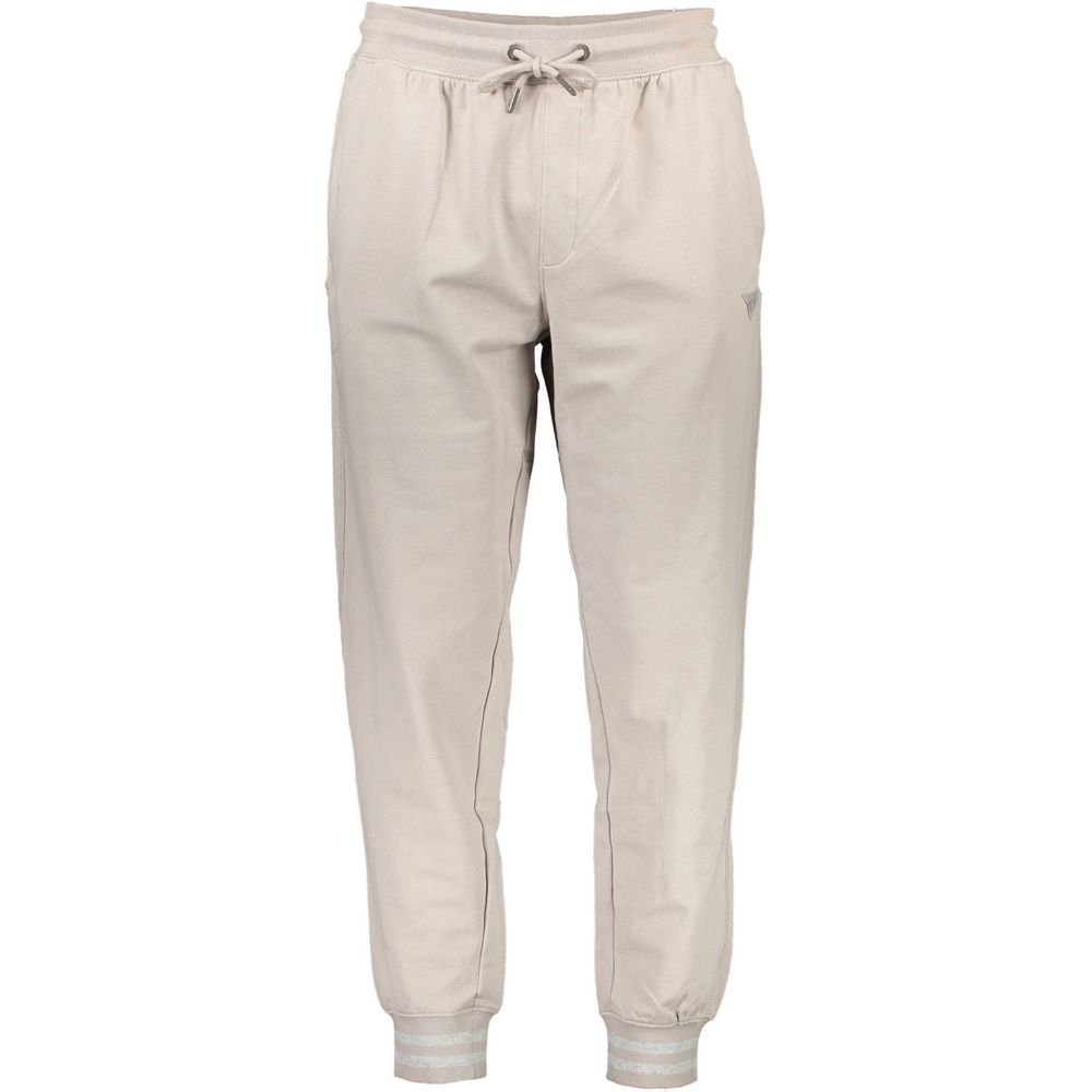 Pantalon de jogging pour homme Guess Jeans beige en coton, style décontracté avec ceinture élastique et poches latérales.