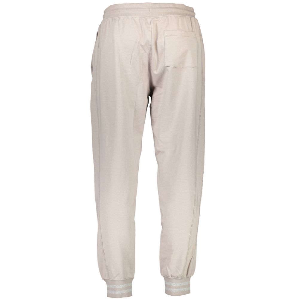 Pantalon de jogging beige en coton pour homme de la marque Guess Jeans, style décontracté et confortable.