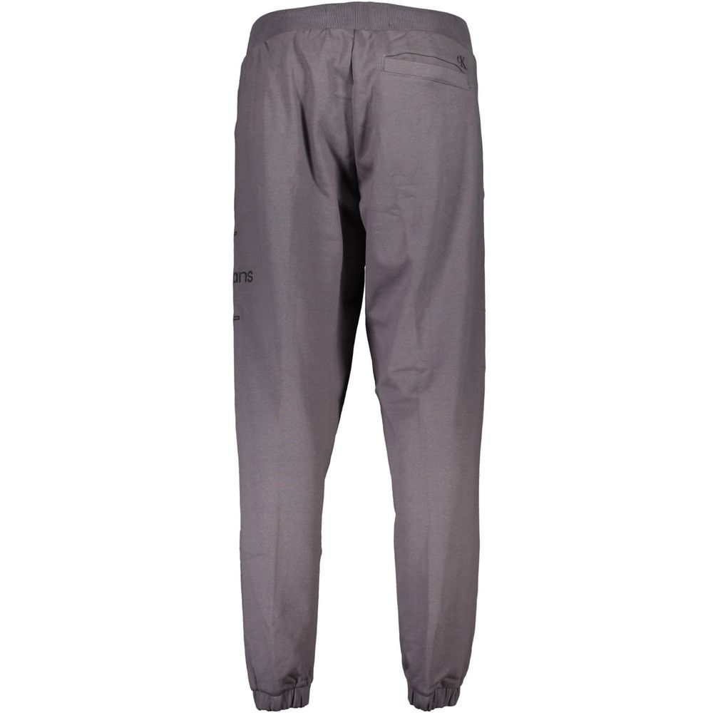 Pantalon de sweat en coton gris pour homme de la marque Calvin Klein, vue de face avec ceinture élastiquée.