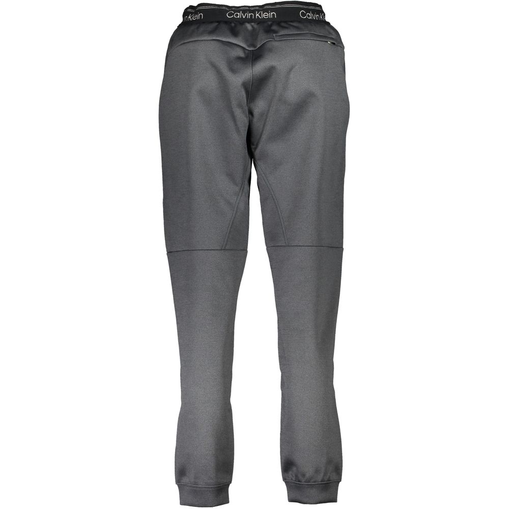 Pantalon de sport femme Calvin Klein en polyester noir, style décontracté avec taille élastique et poches latérales.