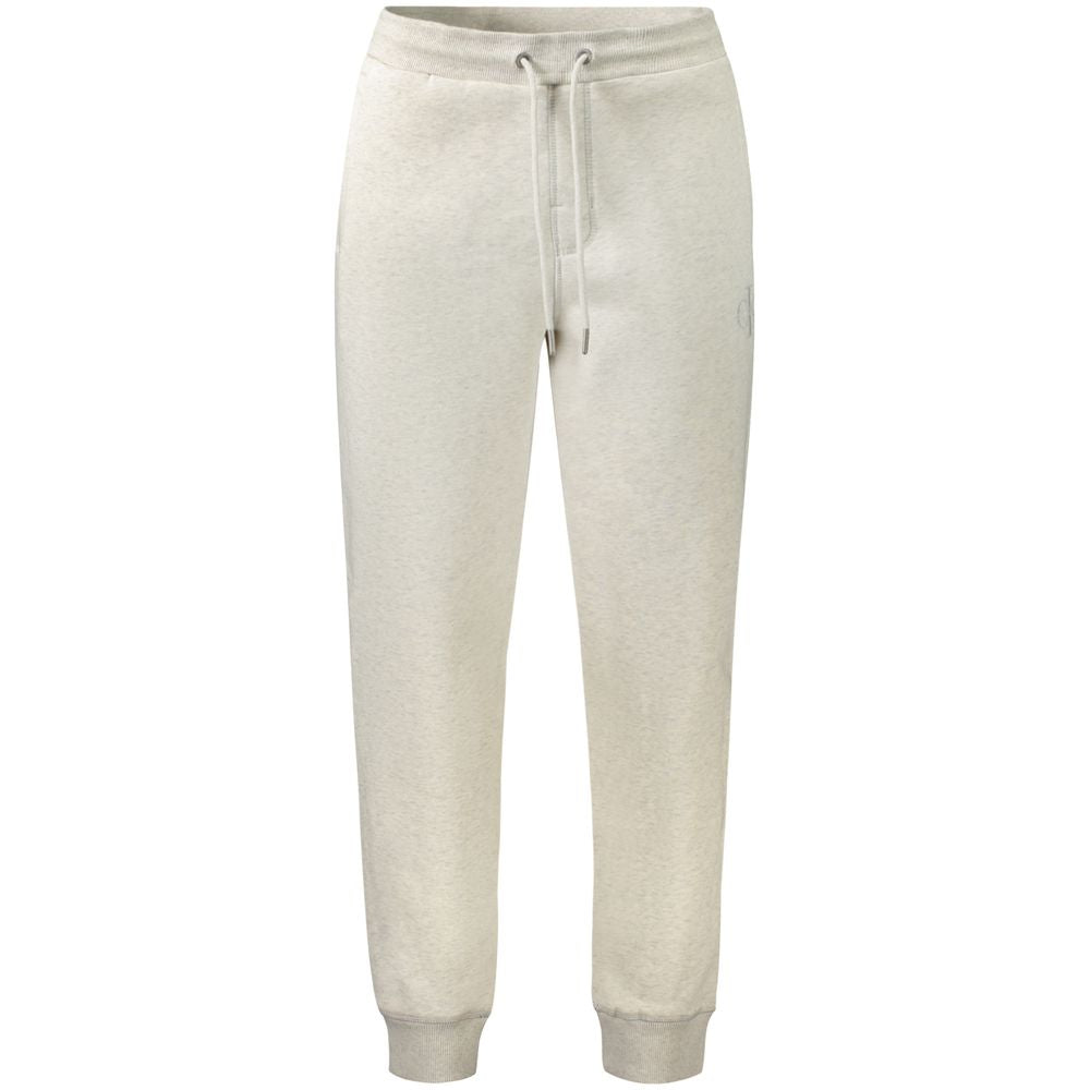Pantalon jogging gris en coton pour homme de la marque Calvin Klein, vue de face avec détails de poche et taille élastique.