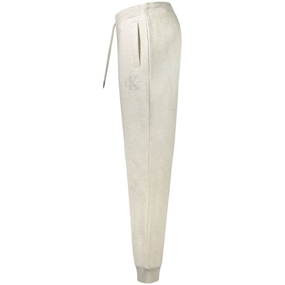 Pantalon de jogging gris en coton pour homme de la marque Calvin Klein, vu de face, avec poches latérales et taille élastique.