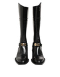 Bottes noires Dolce & Gabbana avec plaque logo en haut du mollet, style élégant et sophistiqué, en cuir.