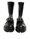 Bottes motardes noires Dolce & Gabbana avec plaque logo, mi-mollet, en cuir, style audacieux et mode urbaine.