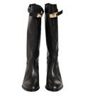 Bottes Dolce & Gabbana noires avec plaque logo sur le mollet, design élégant et moderne, chaussures en cuir pour femmes.
