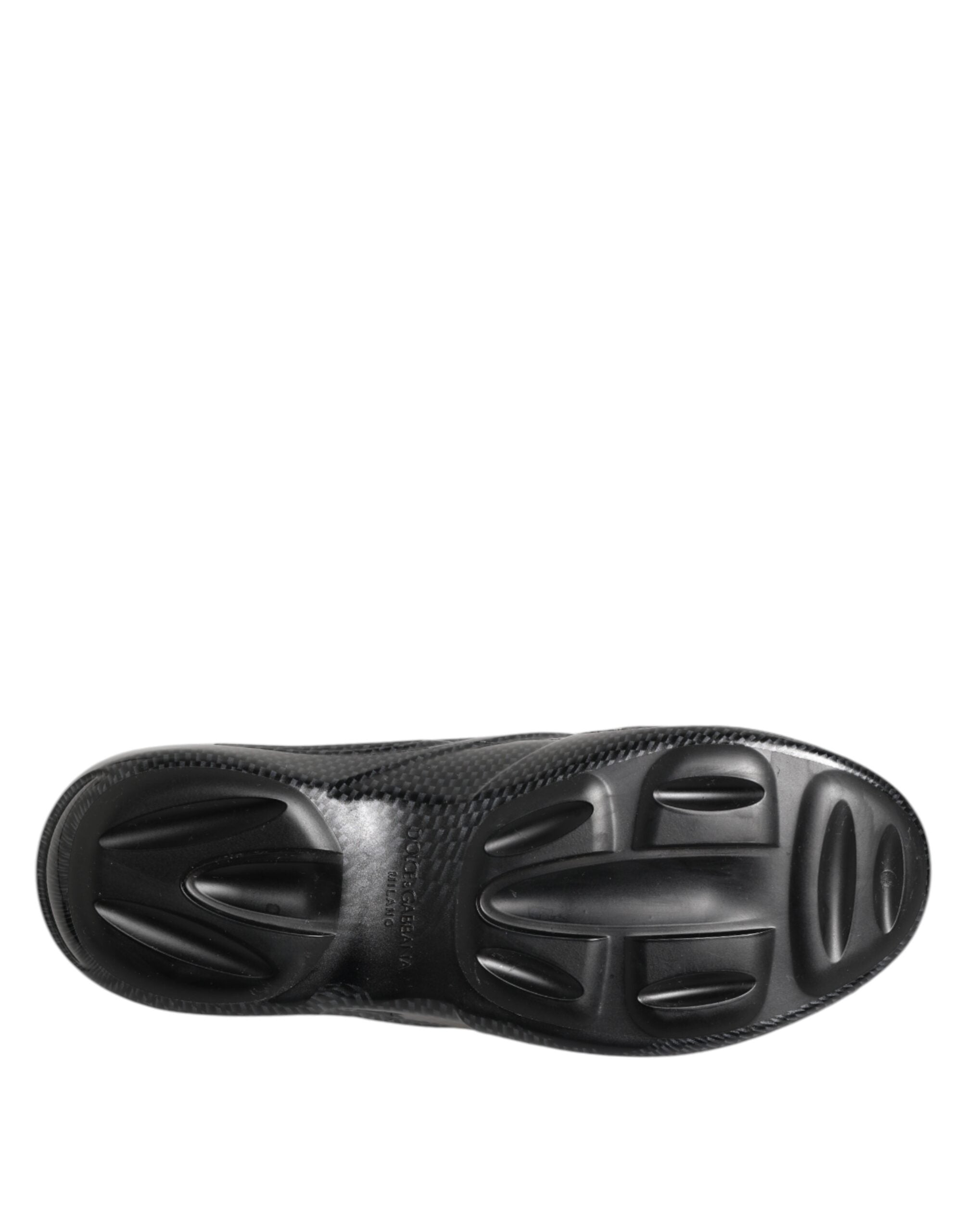 Chaussures Dolce & Gabbana en caoutchouc noir, sandales à talon plat et semelle robuste, style décontracté et moderne.