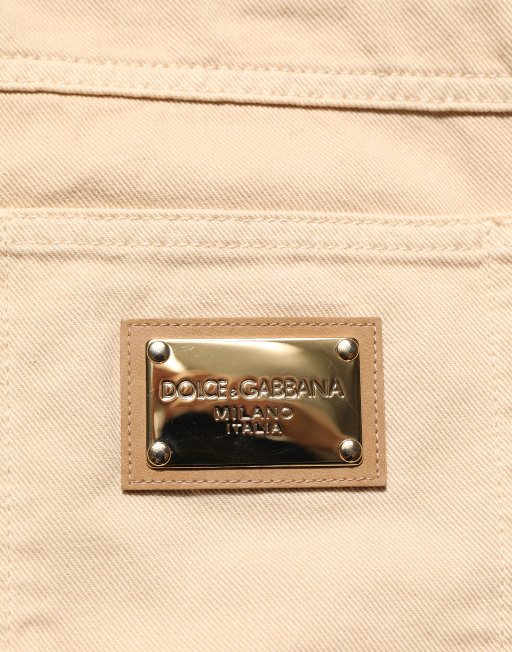 Jeans slim en coton beige Dolce & Gabbana pour homme, coupe régulière, style denim, visible sur l'image.