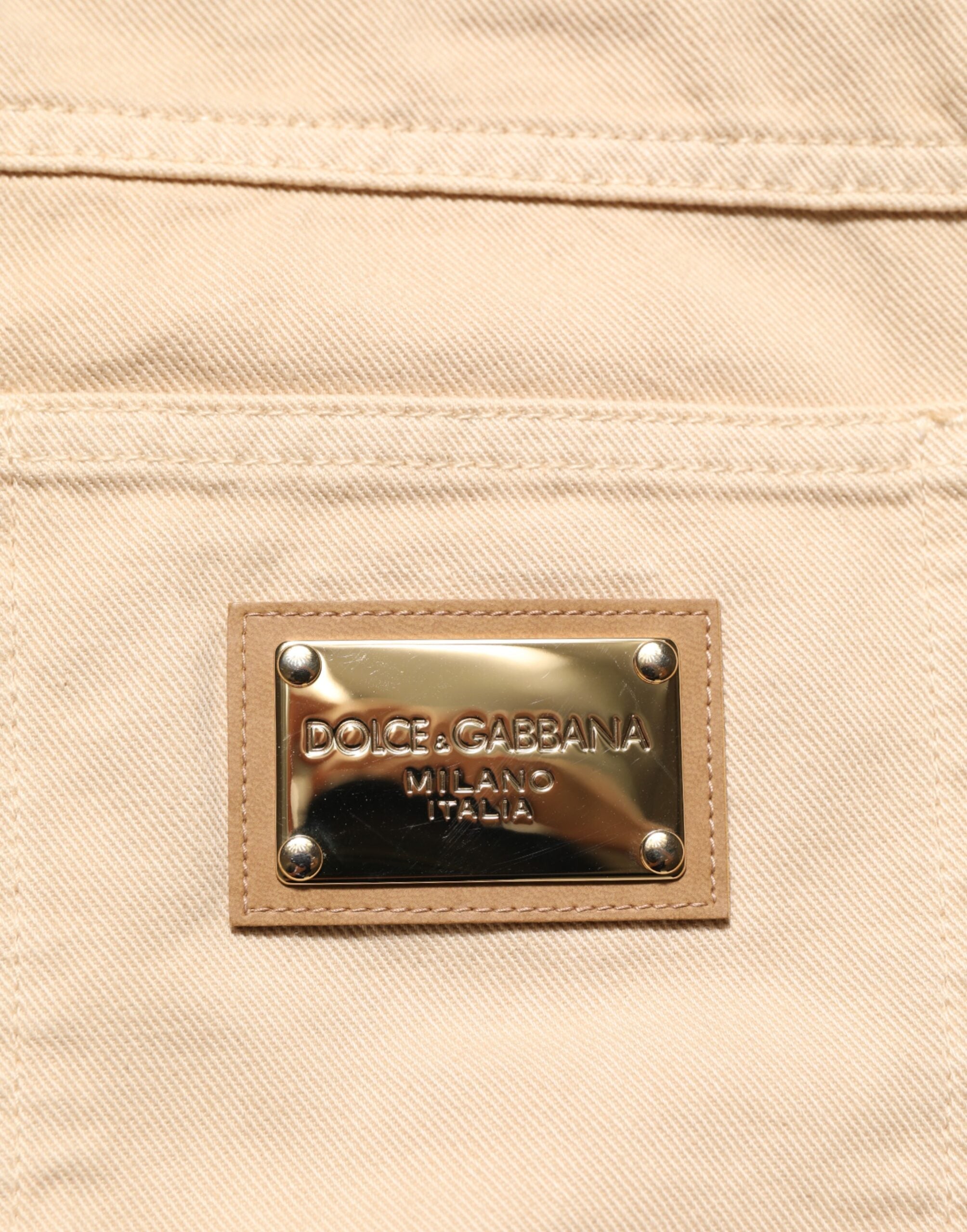 Jeans slim en coton beige Dolce & Gabbana pour homme, coupe régulière, style denim, visible sur l'image.