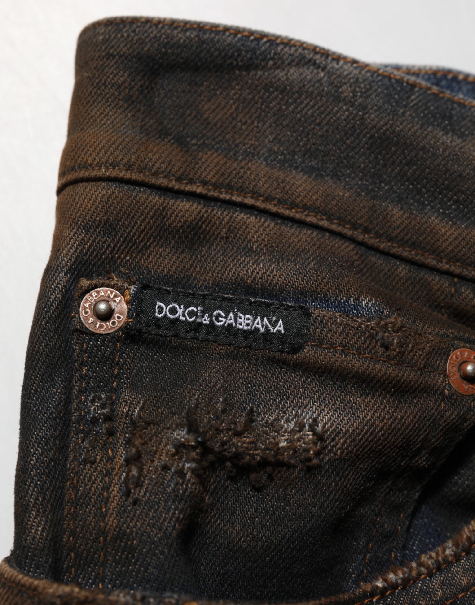 Jeans homme skinny en denim noir tacheté en coton de Dolce & Gabbana, style déchiré et ajusté.