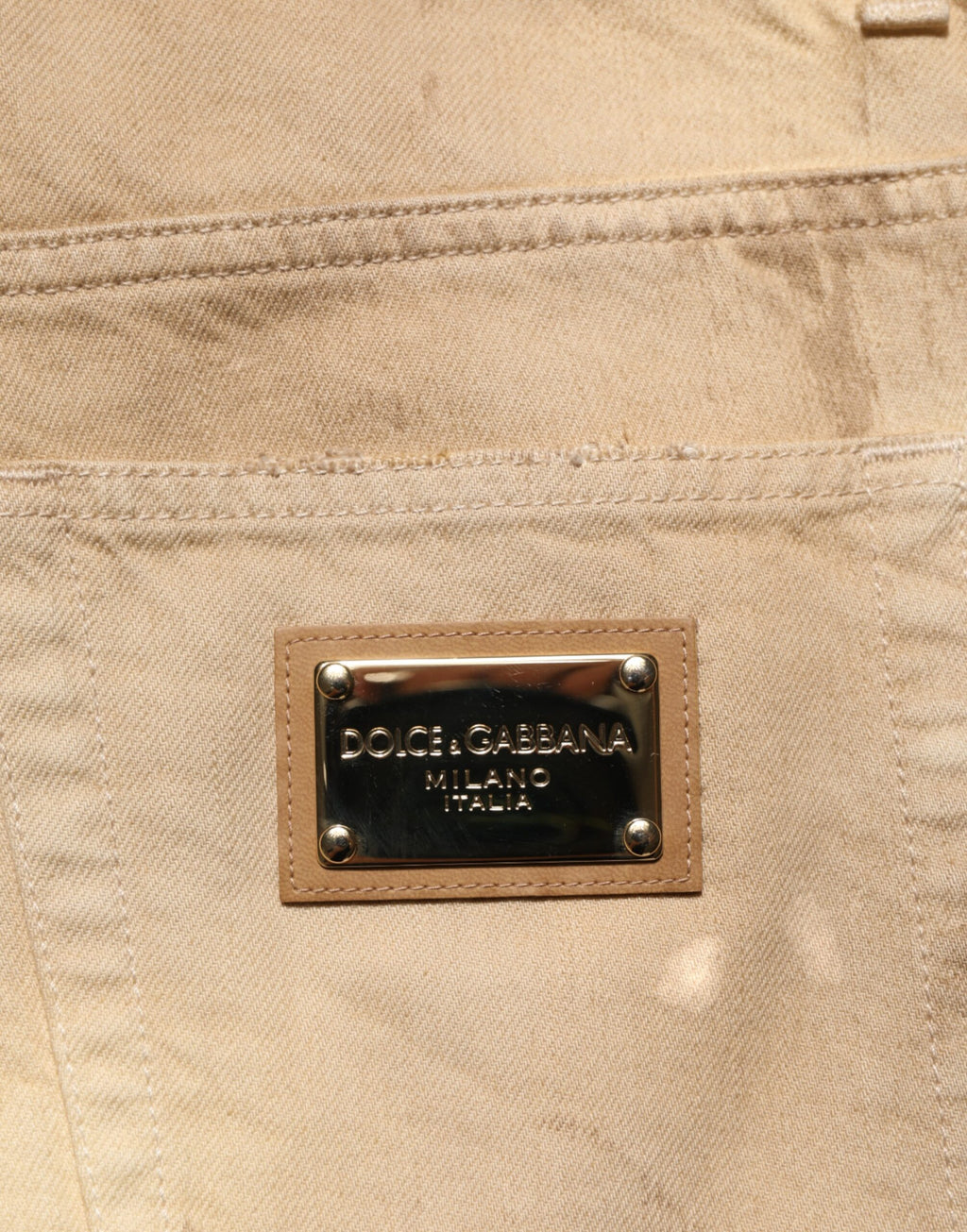 Jeans homme en denim beige Dolce & Gabbana, coupe ample et déchirée, en coton avec style décontracté.