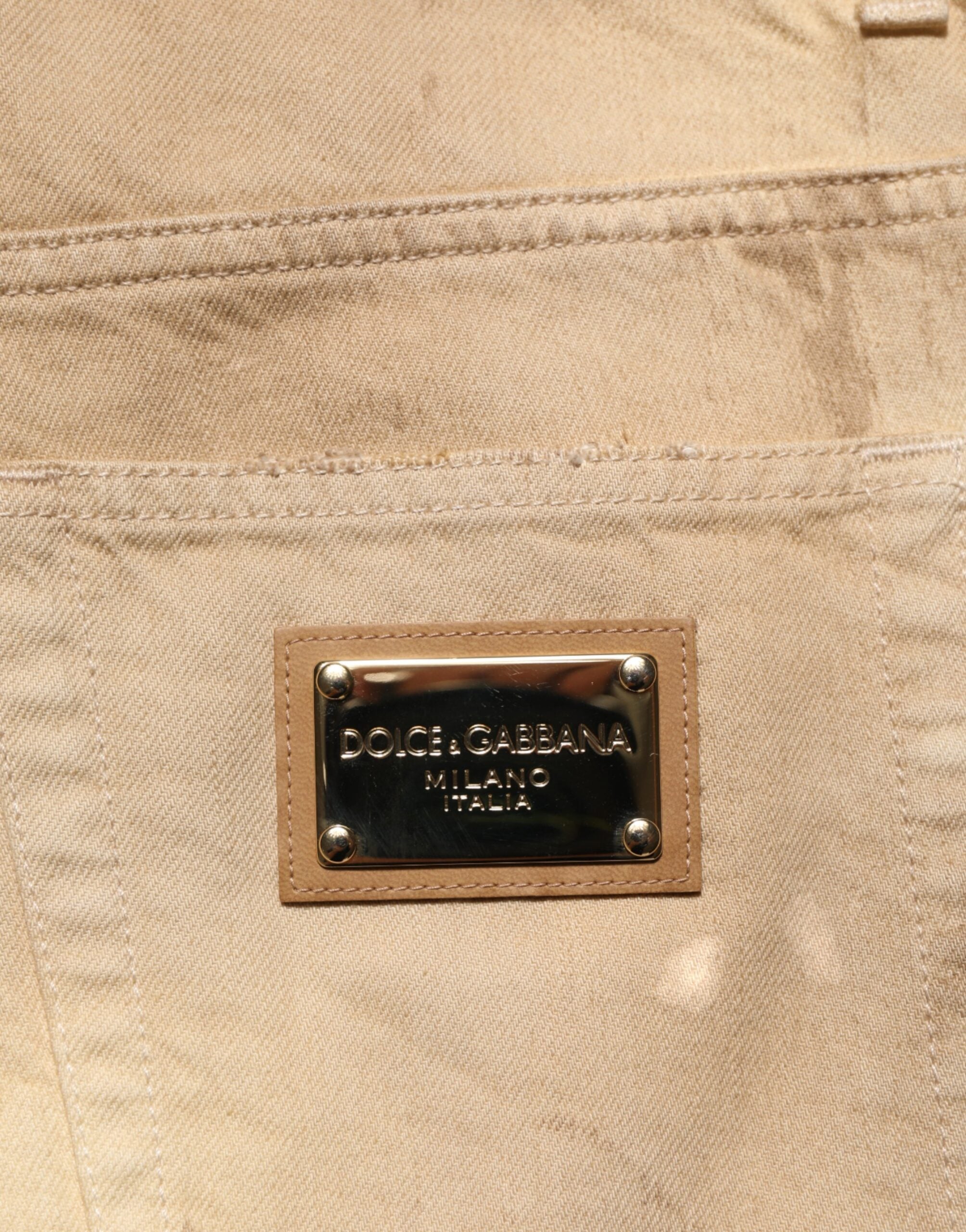 Jeans homme en denim beige Dolce & Gabbana, coupe ample et déchirée, en coton avec style décontracté.
